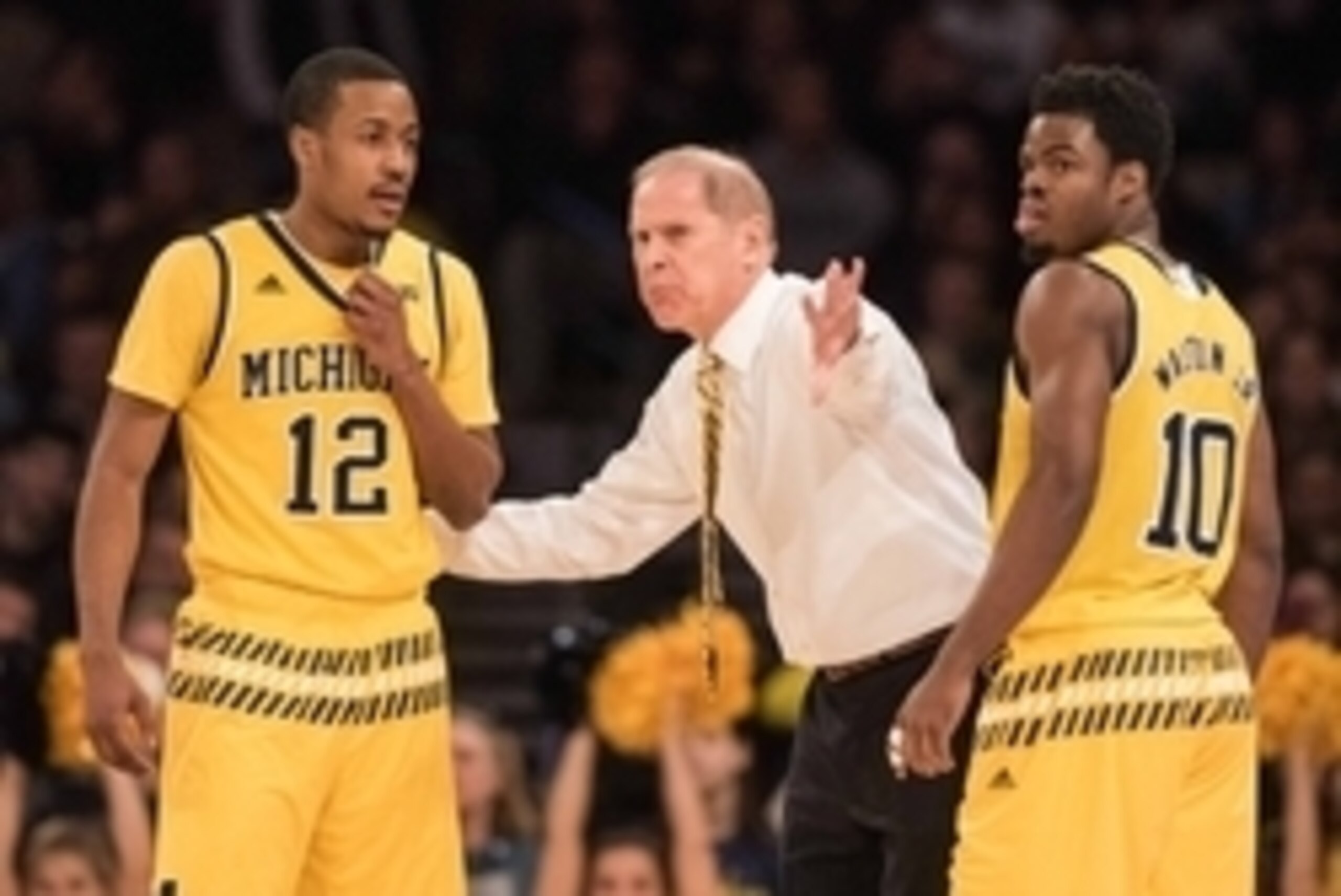 Jan 30, 2016; New York, NY, USA; Michigan Wolverines head coach John Beilein talking with Michigan Wolverines guard Muhammad-Ali Abdur-Rahkman (12) and Michigan Wolverines guard Derrick Walton Jr. (10) in the first  half at Madison Square Garden. Michigan