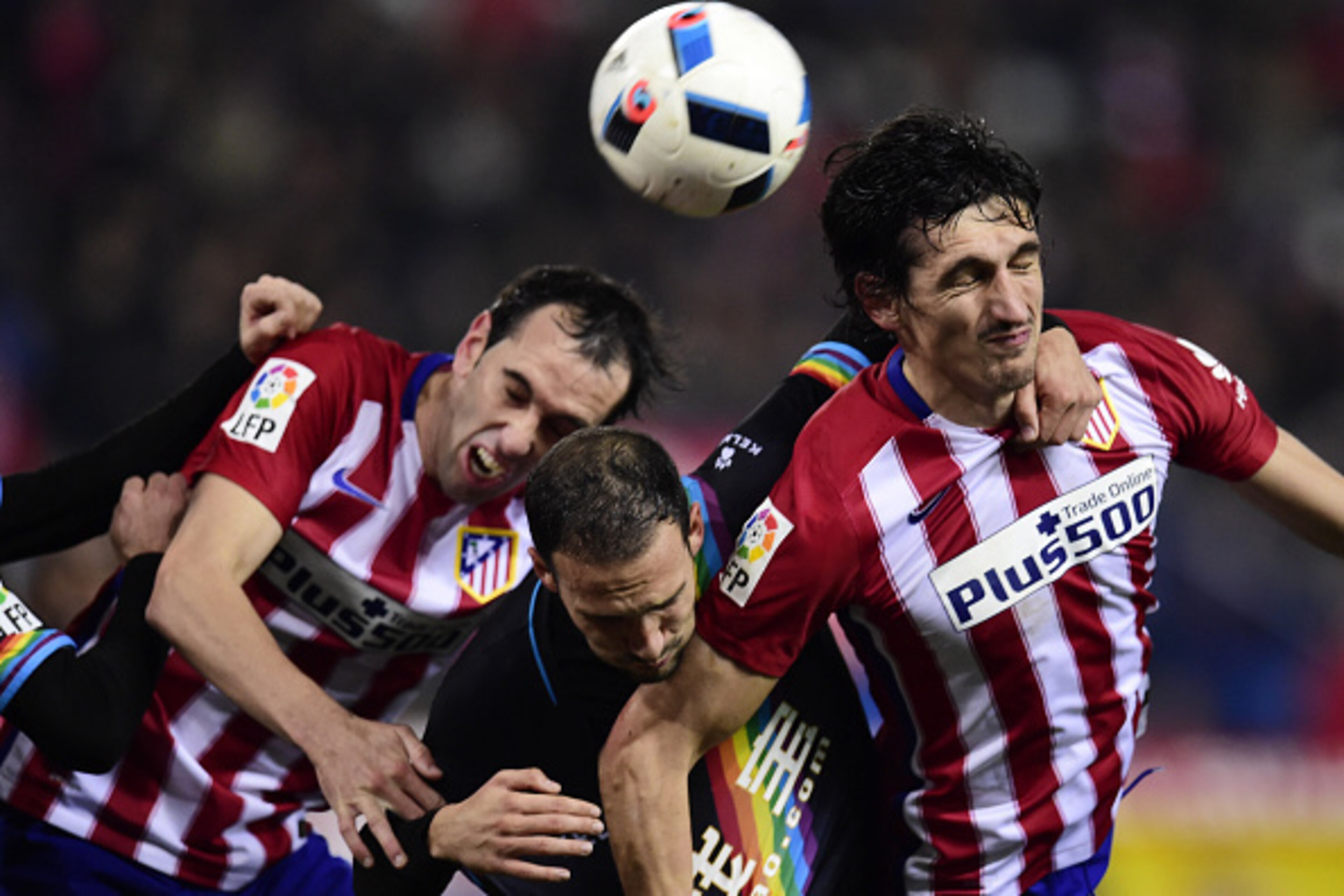 Atletico Madrid's Montenegrin defender Stefan Savic (R) and Atletico Madrid's Uruguayan defender Diego Godin (L) vie with Rayo Vallecano's defender Jose Ignacio Martinez Garcia during the Spanish Copa del Rey (King's Cup) round of 16 second leg football m Atletico Madrid's Montenegrin defender Stefan Savic (R) and Atletico Madrid's Uruguayan defender Diego Godin (L) vie with Rayo Vallecano's defender Jose Ignacio Martinez Garcia during the Spanish Copa del Rey (King's Cup) round of 16 second leg football m