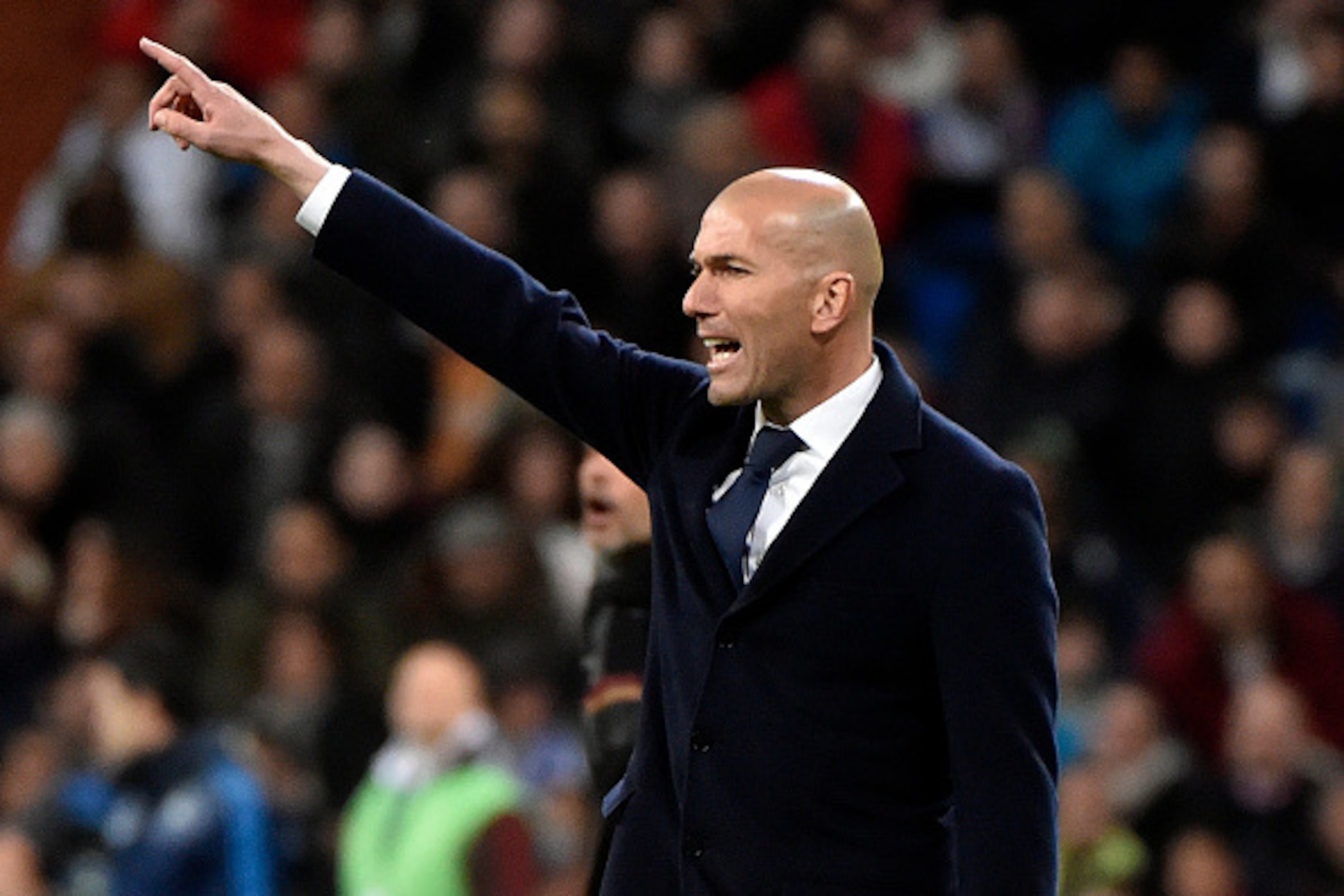 Real Madrid's French coach Zinedine Zidane gestures during the UEFA Champions League round of 16, second leg football match Real Madrid FC vs AS Roma at the Santiago Bernabeu stadium in Madrid on March 8, 2016. / AFP / GERARD JULIEN        (Photo credit s