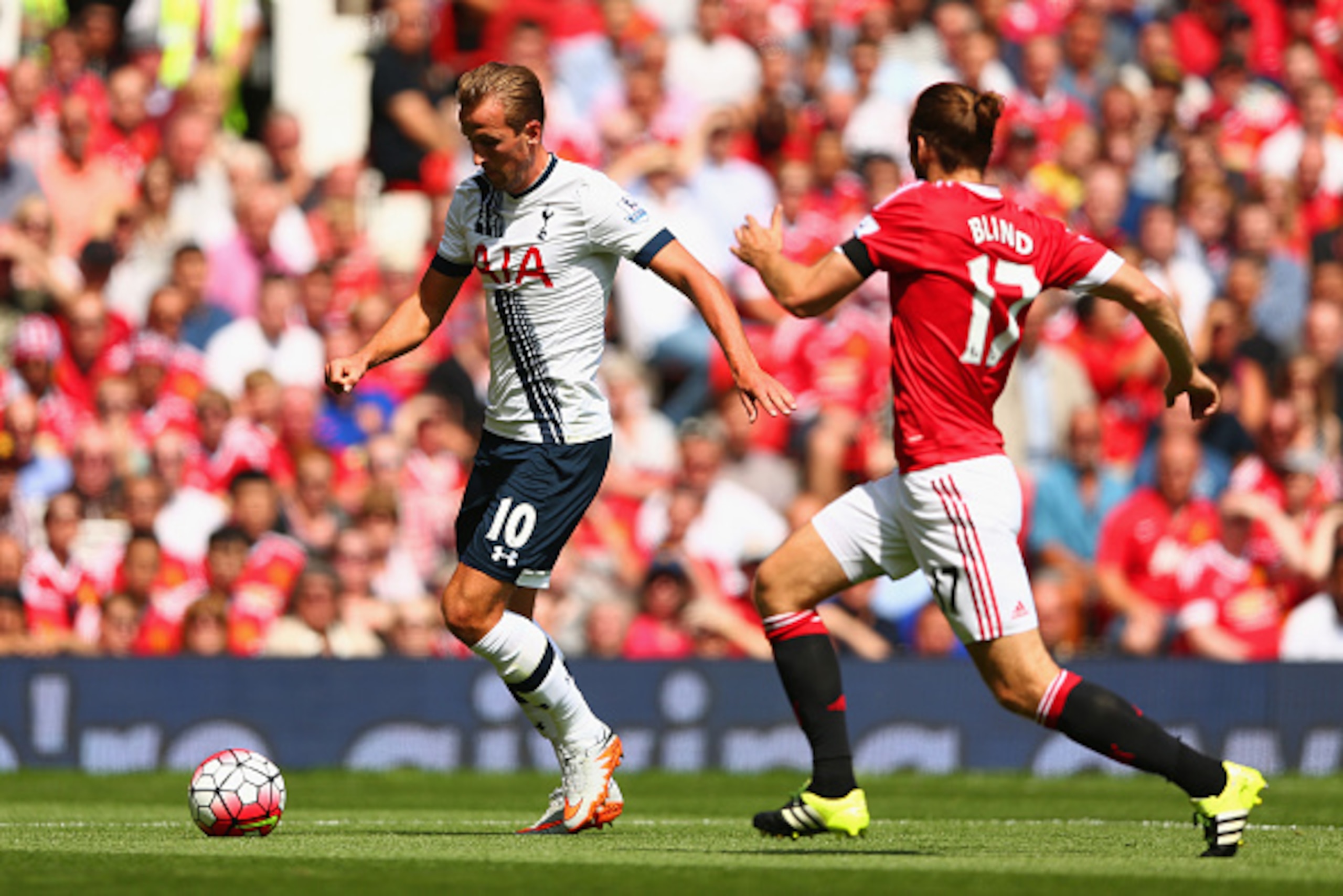 MANCHESTER, ENGLAND - AUGUST 08: Harry Kane of Tottenham Hotspur and Daley Blind of Manchester United compete for the ball during the Barclays Premier League match between Manchester United and Tottenham Hotspur at Old Trafford on August 8, 2015 in Manche