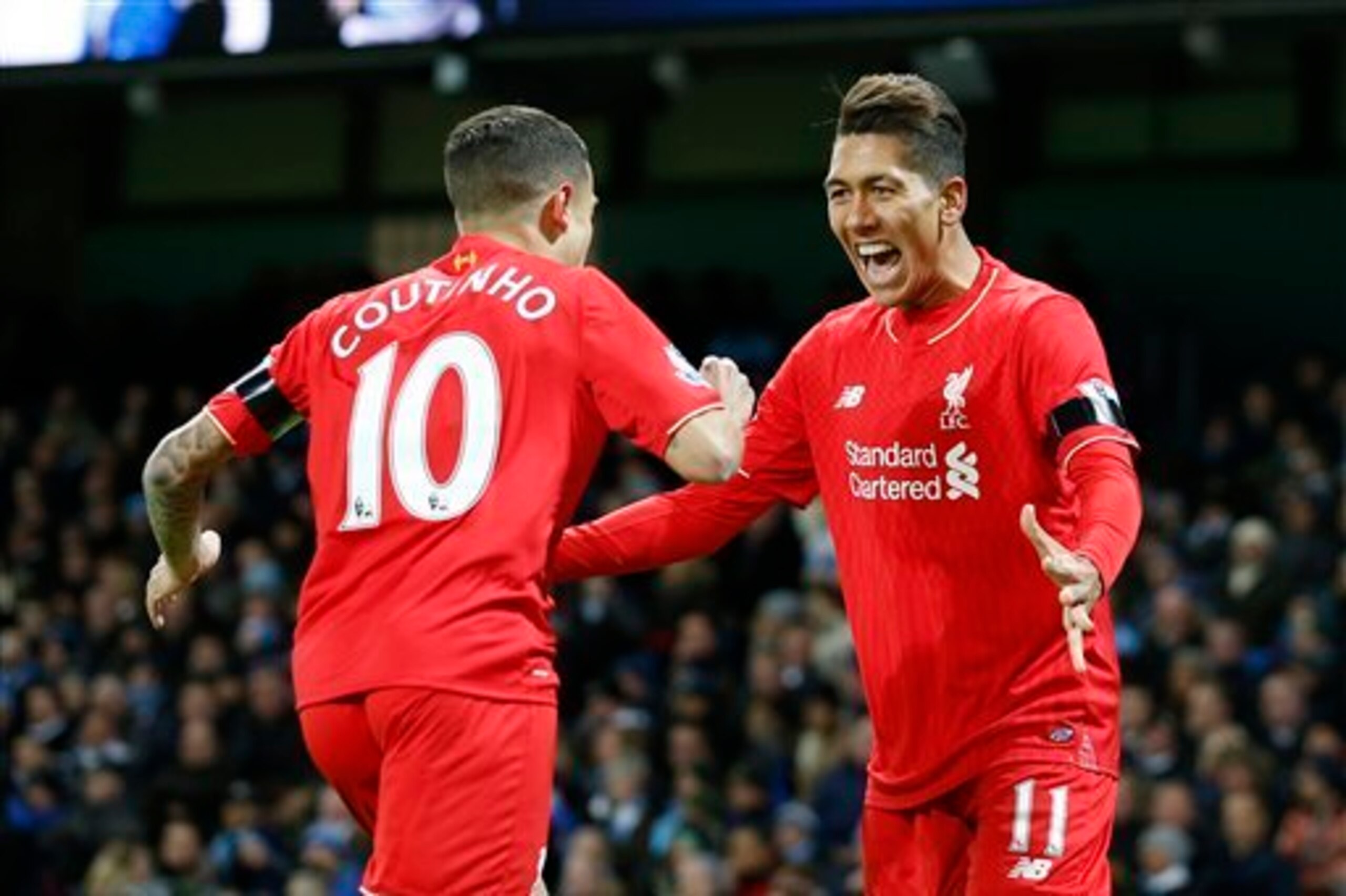 Coutinho and Firmino celebrate.