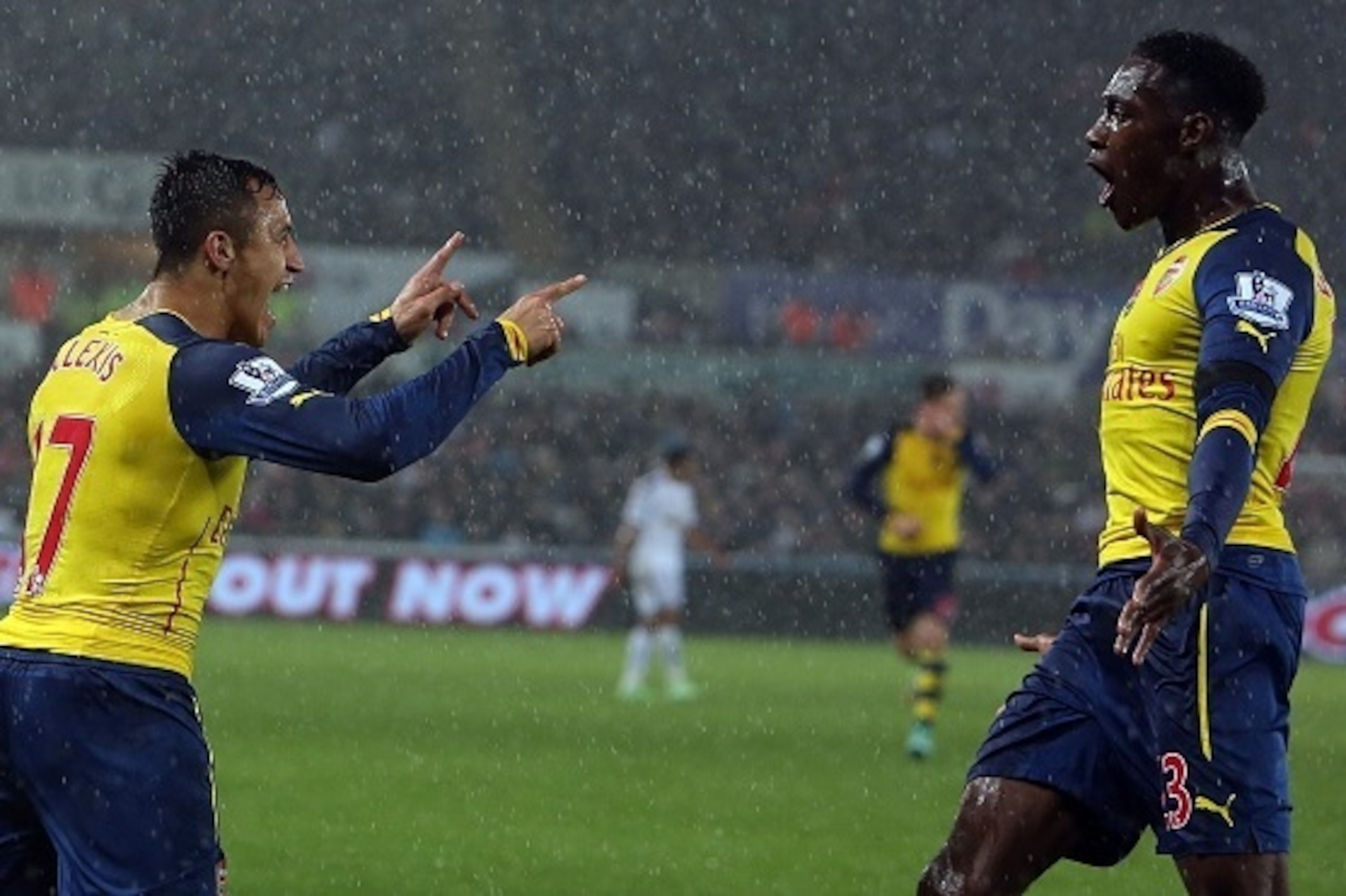 Arsenal's Chilean striker Alexis Sanchez (L) celebrates with team mate English striker Danny Welbeck (R) after scoring the opening goal during the English Premier League football match between Swansea City and Arsenal at The Liberty Stadium in Swansea, so