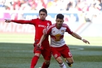 Mar 6, 2016; Harrison, NJ, USA;Toronto FC midfielder Marco Delgado (18) and New York Red Bulls midfielder Felipe Martins (8) battle for the ball  during second half at Red Bull Arena.The Toronto FC defeated the New York Red Bulls 2-0.
 Mandatory Credit: N