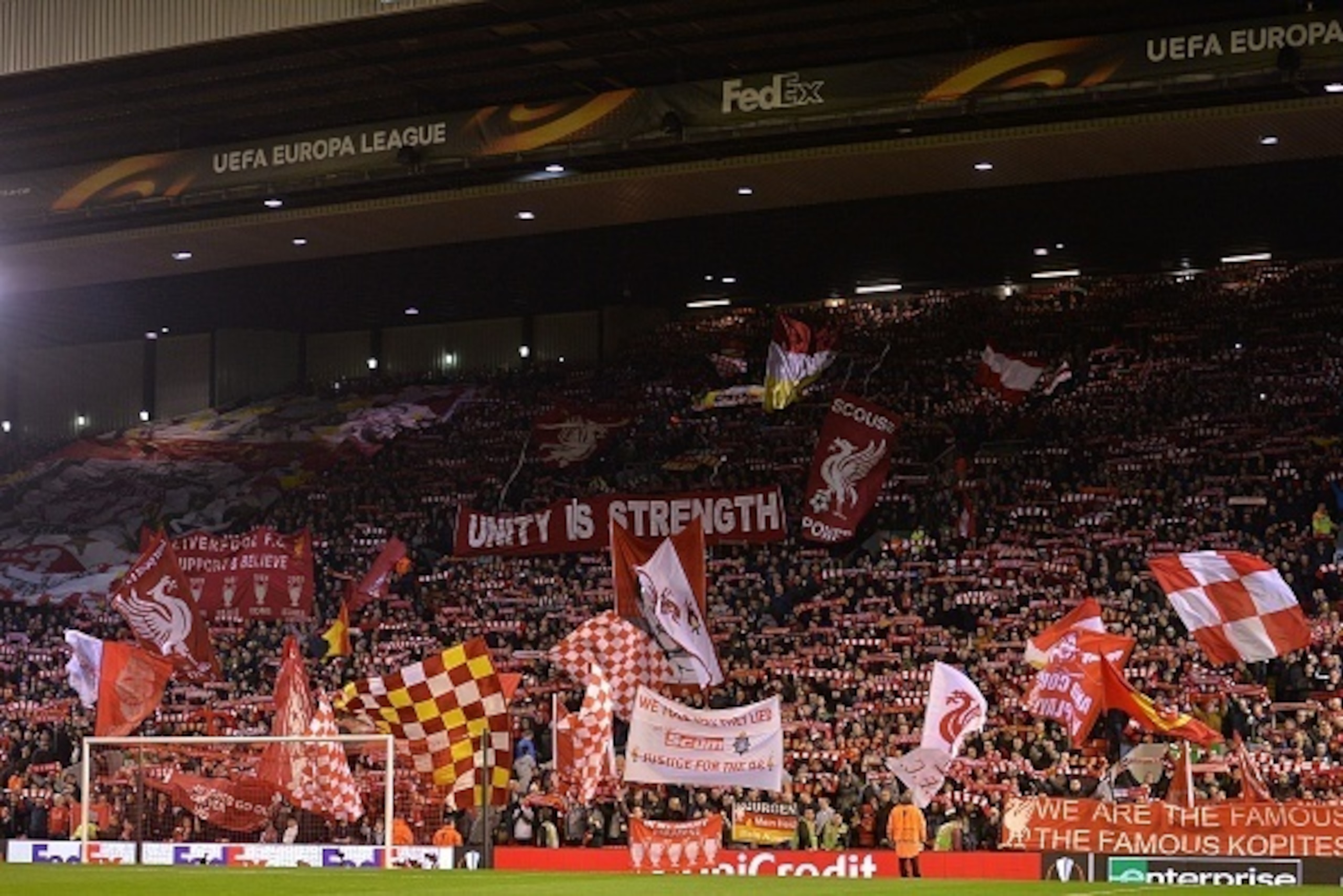 Liverpool fans wave flags and banners ahead of the UEFA Europa League round of 16, first leg football match between Liverpool and Manchester United at Anfield in Liverpool, northwest England on March 10, 2016. / AFP / PAUL ELLIS        (Photo credit shoul
