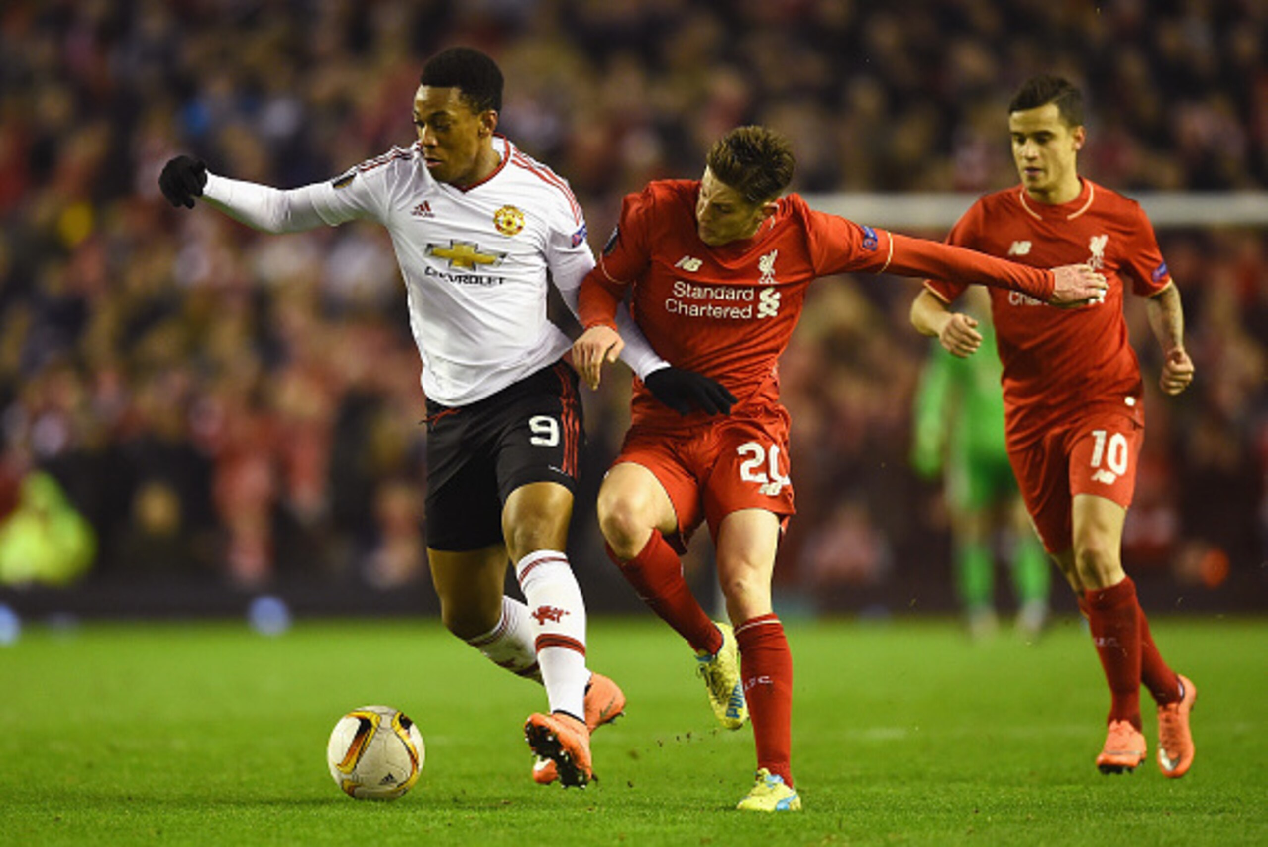 LIVERPOOL, ENGLAND - MARCH 10:  Anthony Martial of Manchester United battles with Adam Lallana of Liverpool during the UEFA Europa League Round of 16 first leg match between Liverpool and Manchester United at Anfield on March 10, 2016 in Liverpool, United