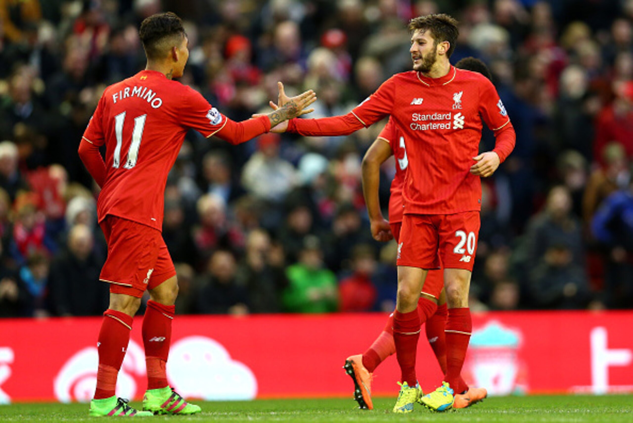 LIVERPOOL, ENGLAND - FEBRUARY 06: Adam Lallana (R) of Liverpool celebrates scoring his team's second goal with his team mate Roberto Firmino (L) during the Barclays Premier League match between Liverpool and Sunderland at Anfield on February 6, 2016 in Li