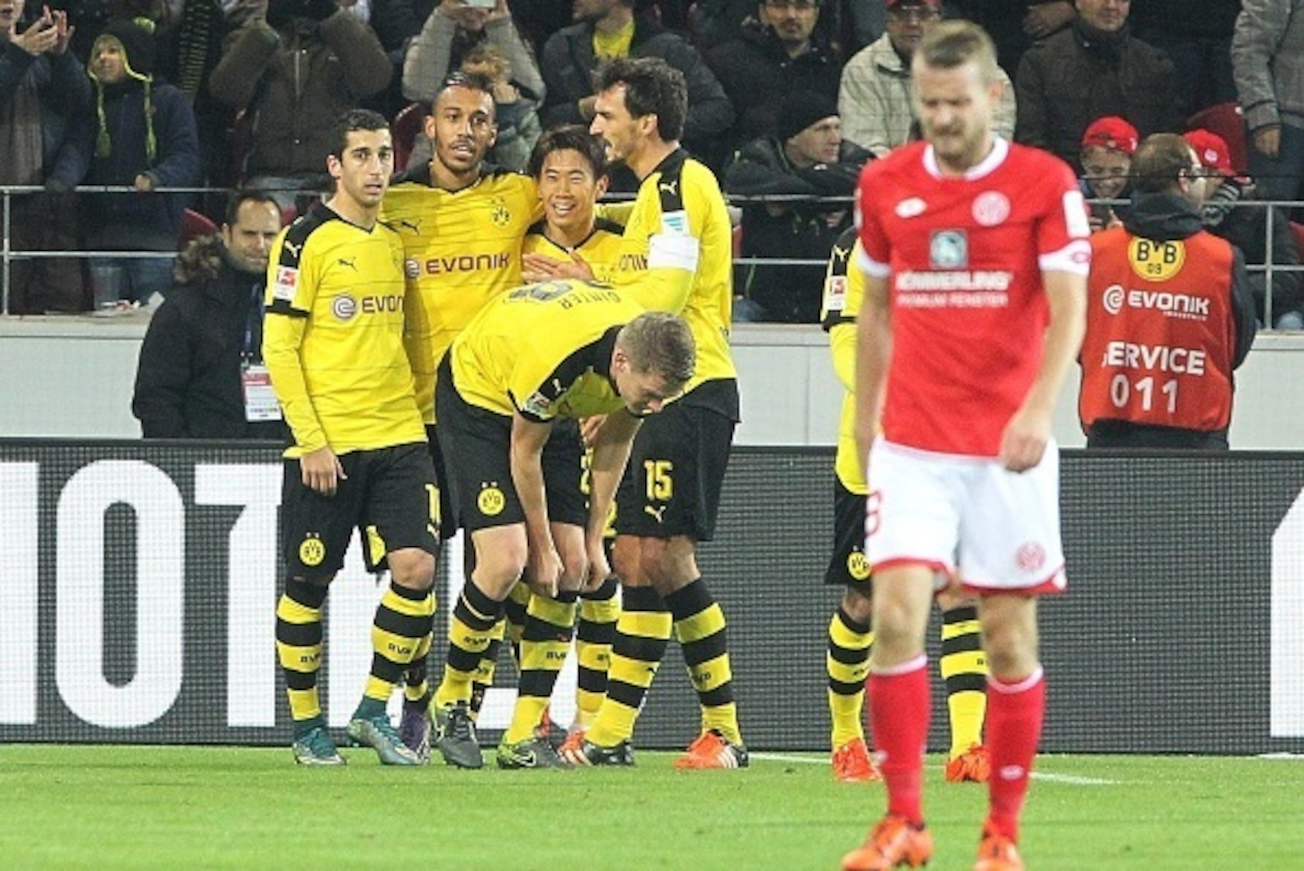Dortmund's Armenian midfielder Henrikh Mkhitaryan (L) celebrates with his teammates after scoring the 0-2 during the German first division Bundesliga football match FSV Mainz 05 vs Borussia Dortmund in Mainz, western Germany, on October 16, 2015. Dortmund