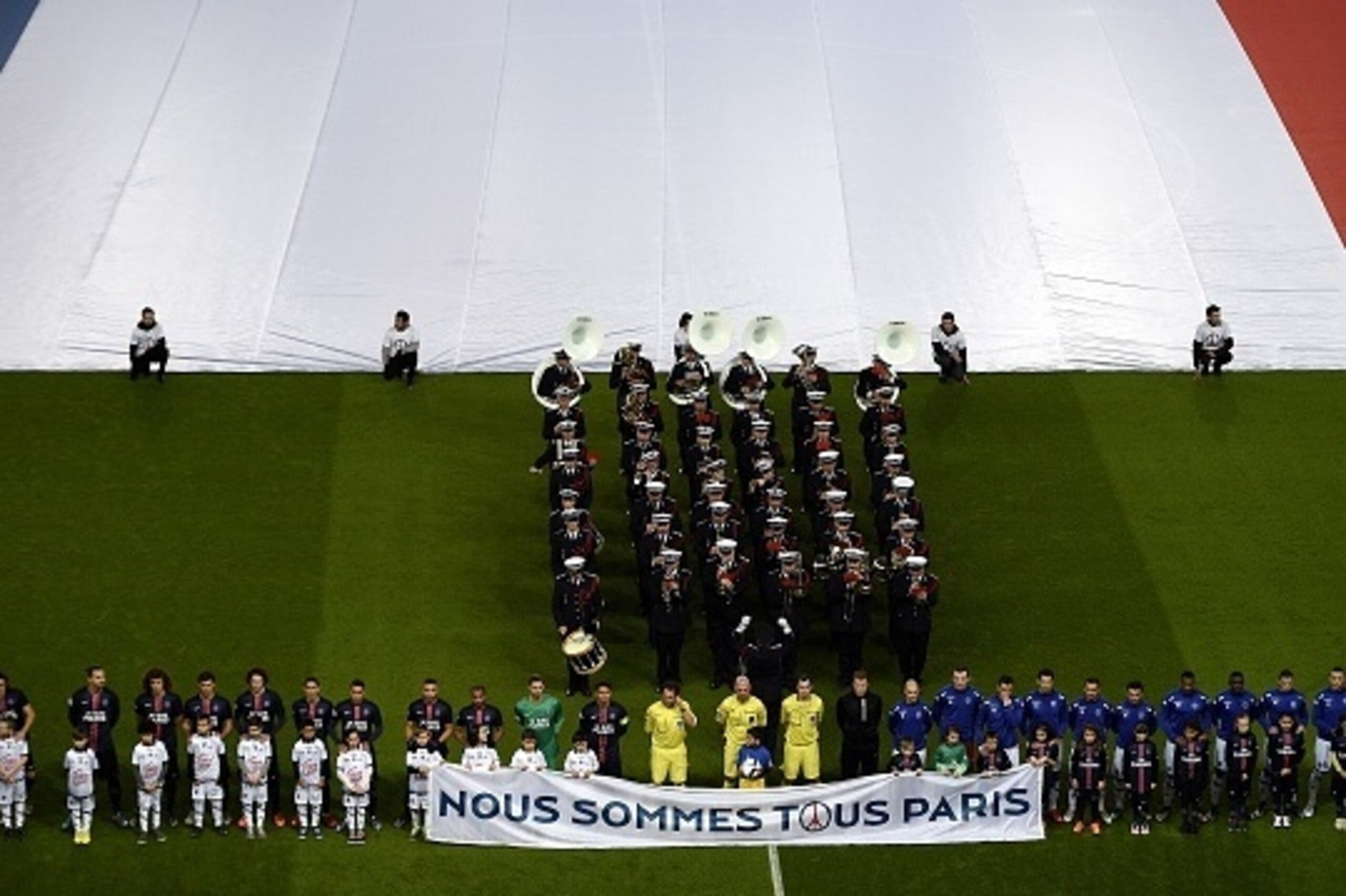 Players and referees standing behind a banner reading 'We are all Paris' observe a minute of silence for the victims of the November 13 terror attacks in Paris ahead of the French L1 football match between Paris Saint-Germain (PSG) and Troyes at the Parc Players and referees standing behind a banner reading 'We are all Paris' observe a minute of silence for the victims of the November 13 terror attacks in Paris ahead of the French L1 football match between Paris Saint-Germain (PSG) and Troyes at the Parc