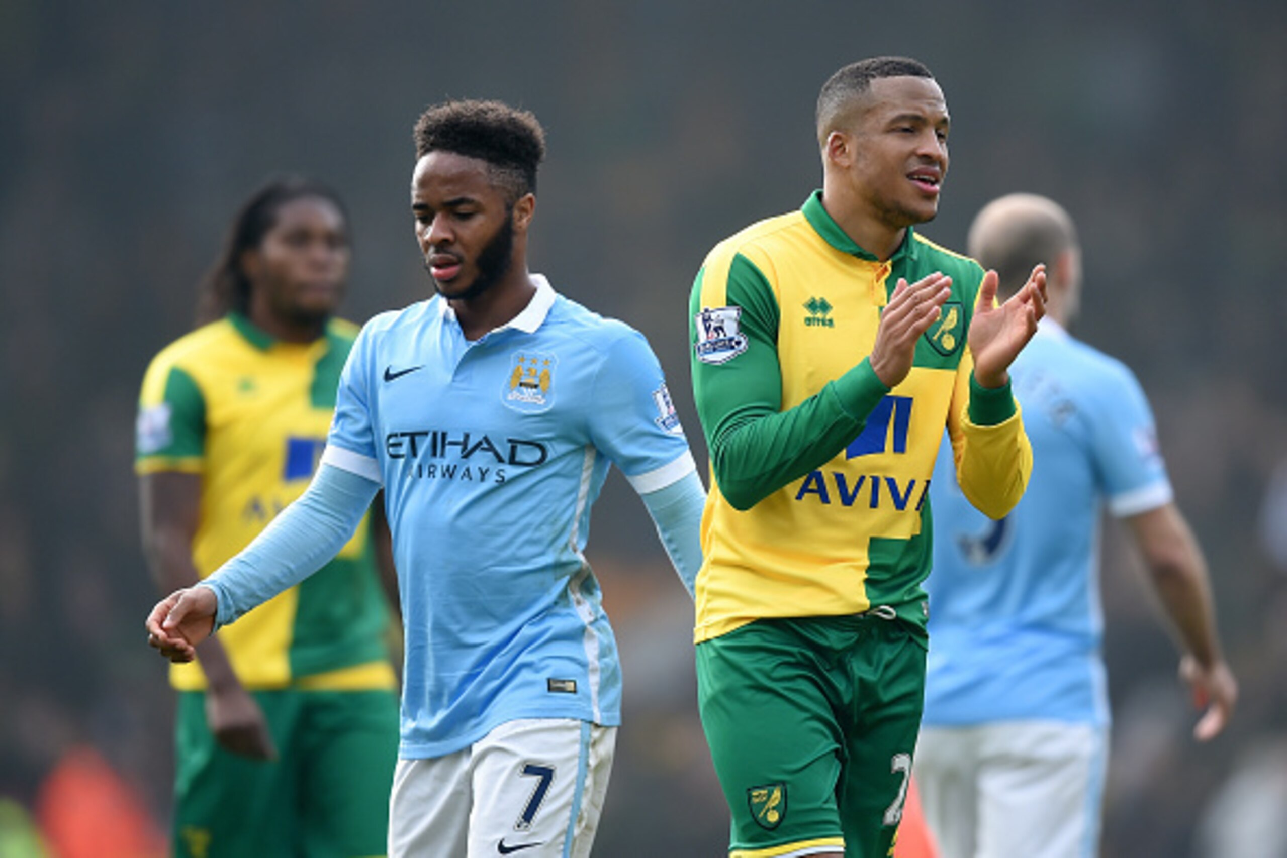 NORWICH, ENGLAND - MARCH 12: Martin Olsson of Norwich City applauds while Raheem Sterling of Manchester City shows his frustration after the scoreless draw in the Barclays Premier League match between Norwich City and Manchester City at Carrow Road on Mar
