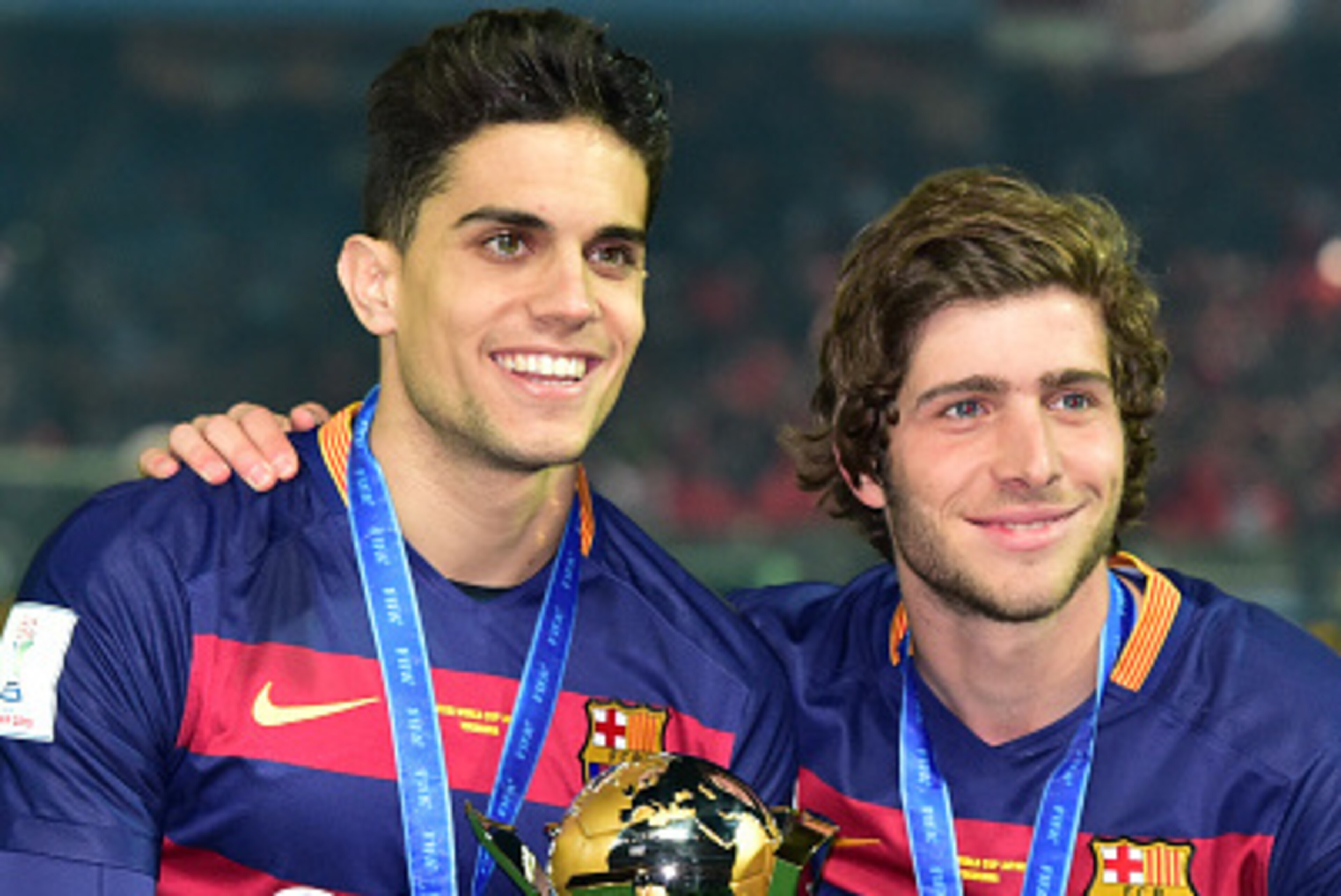 FC Barcelona player Marc Bartra (L) and Sergi Roberto (R) hold the trophy of the FIFA Club World Cup as Barcelona won the FIFA Club World Cup in the final in Yokohama, suburban Tokyo on December 20, 2015. FC Barcelona defeated River Plate 3-0. AFP PHOTO FC Barcelona player Marc Bartra (L) and Sergi Roberto (R) hold the trophy of the FIFA Club World Cup as Barcelona won the FIFA Club World Cup in the final in Yokohama, suburban Tokyo on December 20, 2015. FC Barcelona defeated River Plate 3-0. AFP PHOTO