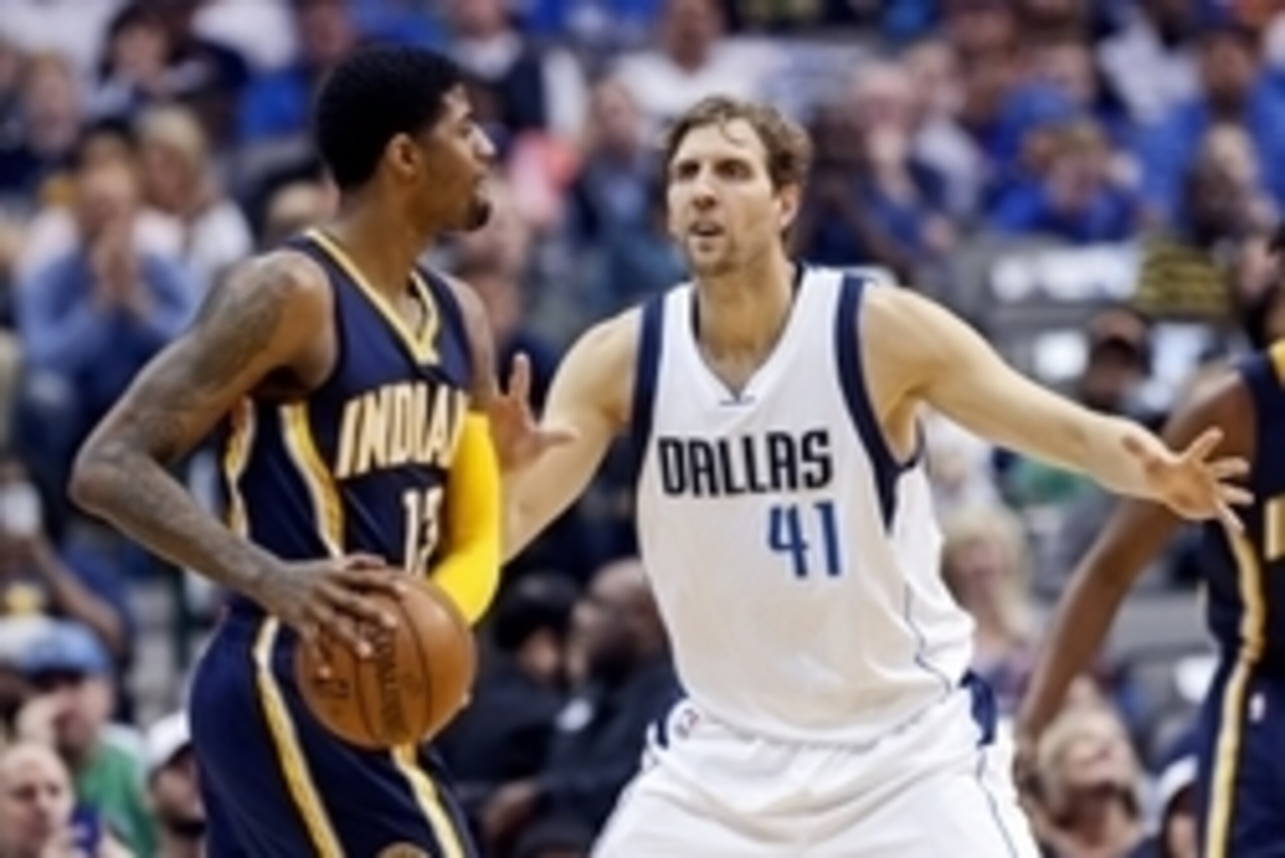 Mar 12, 2016; Dallas, TX, USA; Indiana Pacers forward Paul George (13) looks to pass as Dallas Mavericks forward Dirk Nowitzki (41) defends during the first quarter at American Airlines Center. Mandatory Credit: Kevin Jairaj-USA TODAY Sports