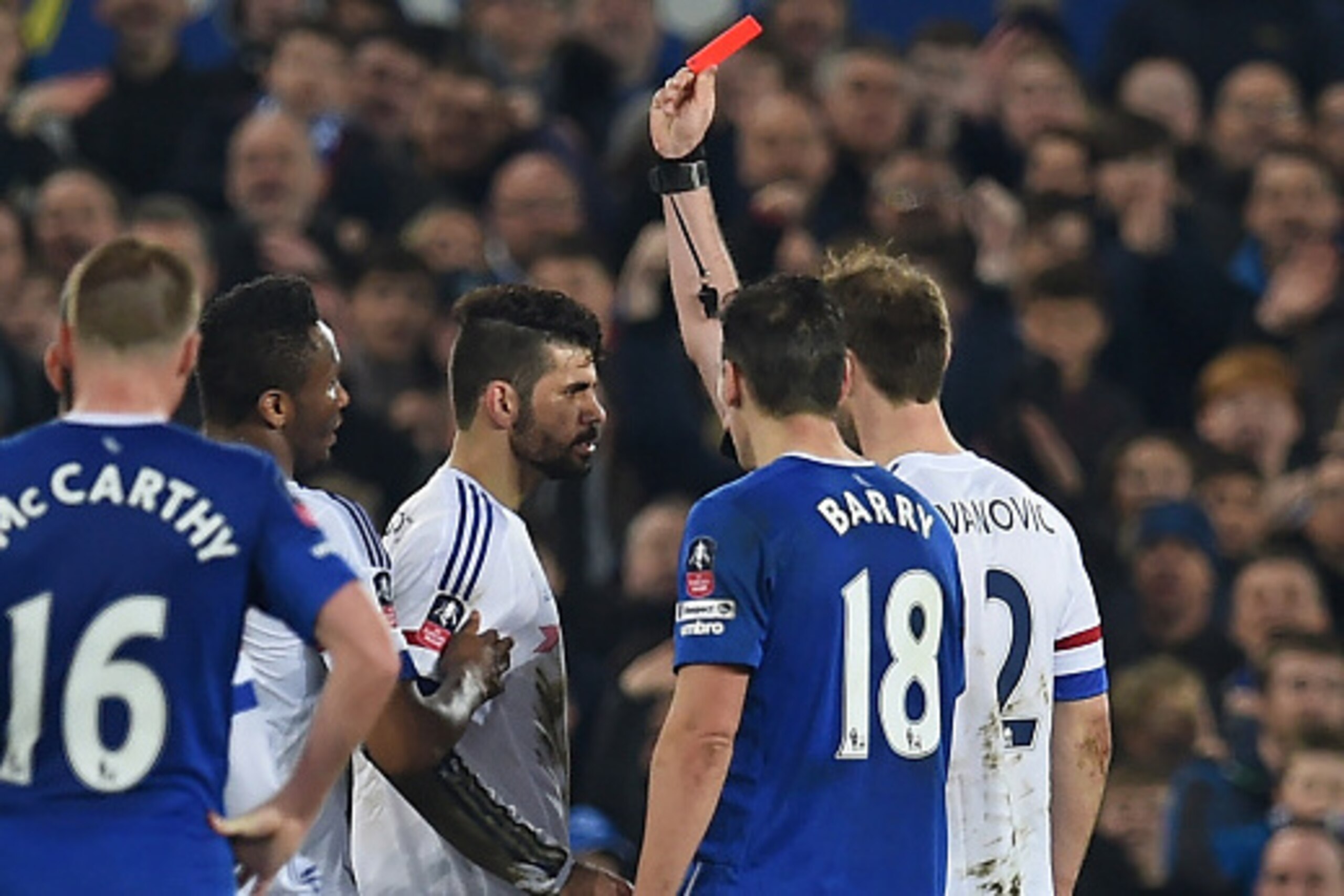 Chelsea's Brazilian-born Spanish striker Diego Costa (C) is shown a red card by referee Michael Oliver during the English FA cup quarter-final football match between Everton and Chelsea at Goodison Park in Liverpool, north west England on March 12, 2016. 
