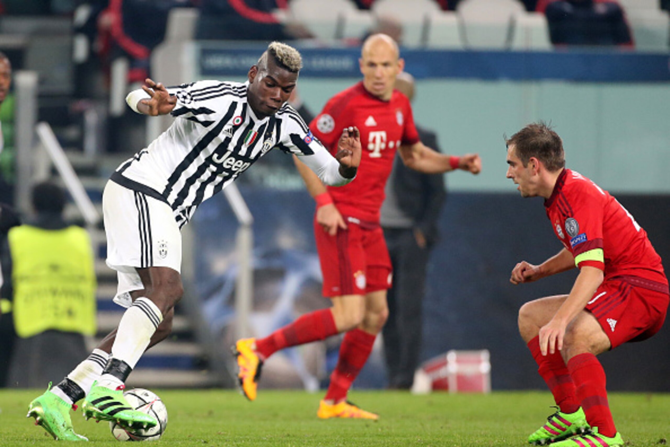 TURIN, ITALY - FEBRUARY 23: Paul Pogba of Juventus and Philipp Lahm of Bayern Muenchen in action during the UEFA Champions League Round of 16 first leg match between Juventus Turin and Bayern Muenchen (Bayern Munich) at Juventus Stadium on February 23, 20