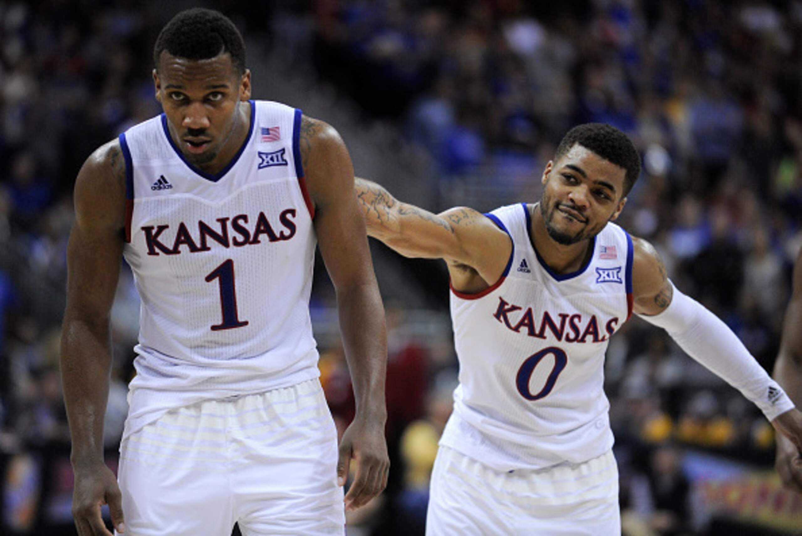 KANSAS CITY, MO - MARCH 12: Frank Mason III #0 slaps Wayne Selden Jr. #1 of the Kansas Jayhawks on the back as Selden goes to the free throw line against the West Virginia Mountaineers in the second half during the championship game of the Big 12 Basketb KANSAS CITY, MO - MARCH 12: Frank Mason III #0 slaps Wayne Selden Jr. #1 of the Kansas Jayhawks on the back as Selden goes to the free throw line against the West Virginia Mountaineers in the second half during the championship game of the Big 12 Basketb