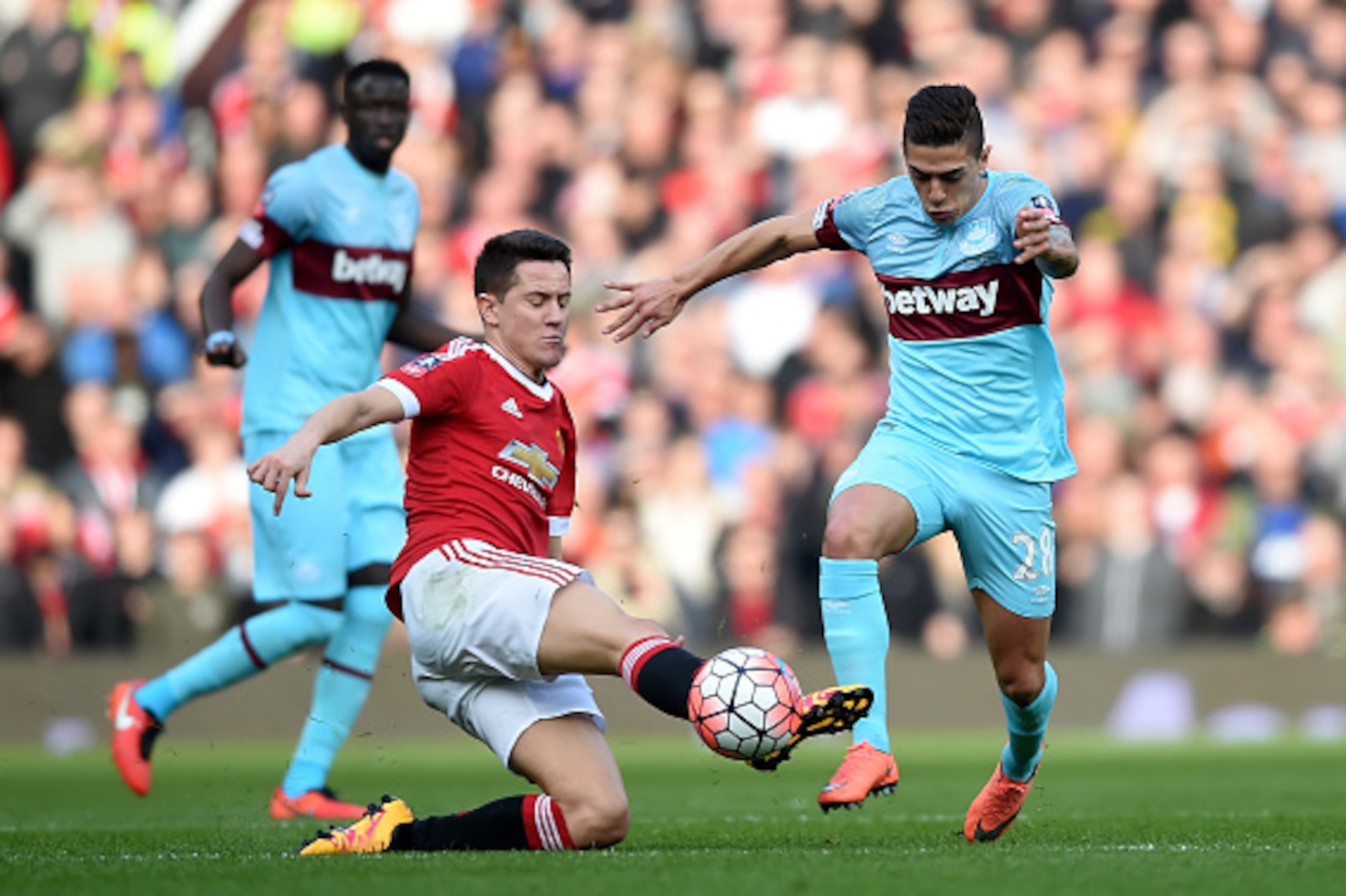 MANCHESTER, ENGLAND - MARCH 13:  Manuel Lanzini of West Ham United is challenged by Ander Herrera of Manchester United during the Emirates FA Cup sixth round match between Manchester United and West Ham United at Old Trafford on March 13, 2016 in Manchest