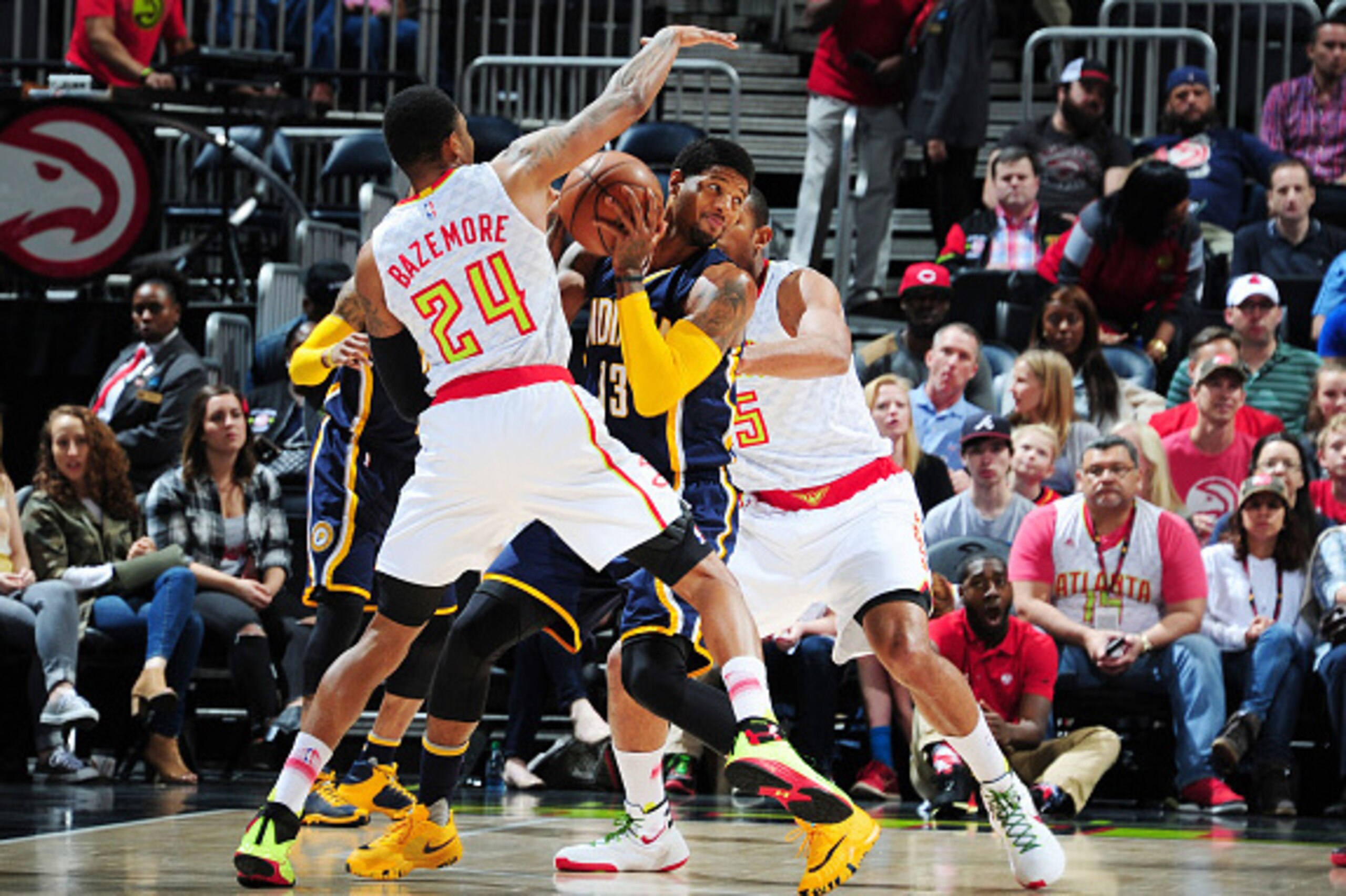 ATLANTA, GA  - MARCH 13: Paul George #13 of the Indiana Pacers defends the abll against Kent Bazemore #24 of the Atlanta Hawks during the game on March 13, 2016 at Philips Arena in Atlanta, Georgia. NOTE TO USER: User expressly acknowledges and agrees tha
