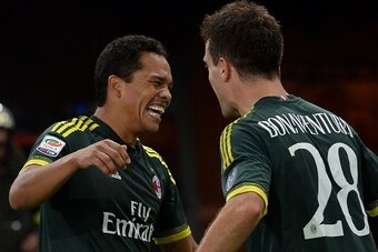 AC Milan's forward from Colombia Carlos Bacca (L) celebrates with teammate AC Milan's midfielder from Italy Giacomo Bonaventura after scoring during the Italian Serie A football match between Lazio and AC Milan at Olympic Stadium in Rome on November 1, 20