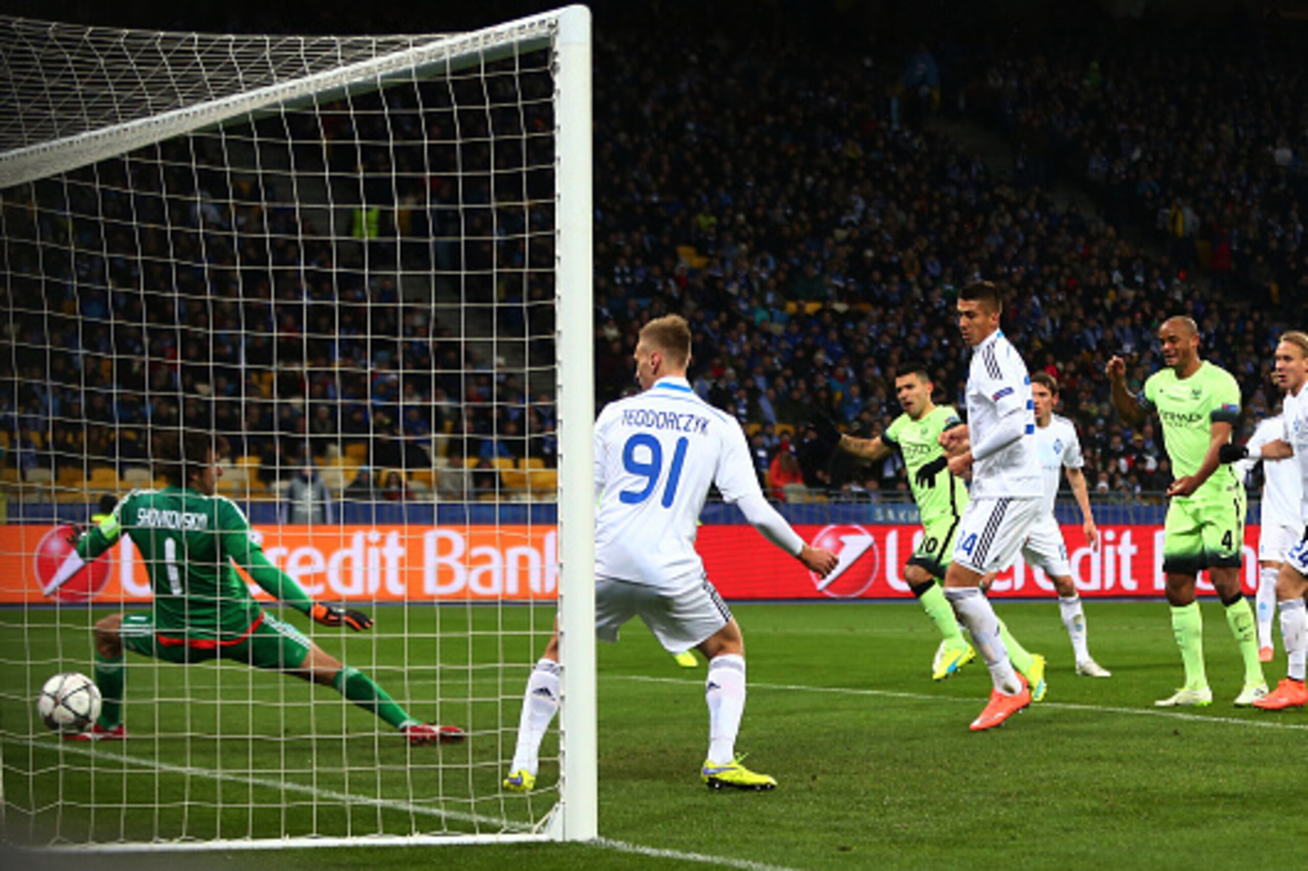 KIEV, UKRAINE - FEBRUARY 24:  Sergio Aguero #10 of Manchester City scores the opening goal past goalkeeper Oleksandr Shovkovskiy of Dynamo Kiev during the UEFA Champions League round of 16, first leg match between FC Dynamo Kyiv and Manchester City FC at 