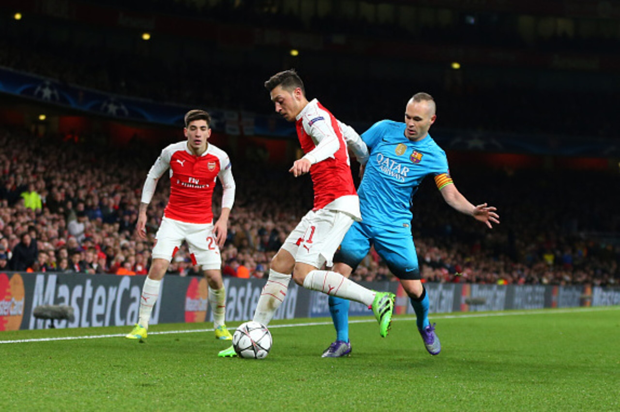 LONDON, ENGLAND - FEBRUARY 23 :  Mesut Ozil of Arsenal and Andres Iniesta of FC Barcelona  during the UEFA Champions League match between Arsenal and Barcelona at the Emirates Stadium on February 23, 2016 in London, United Kingdom.  (Photo by Catherine Iv