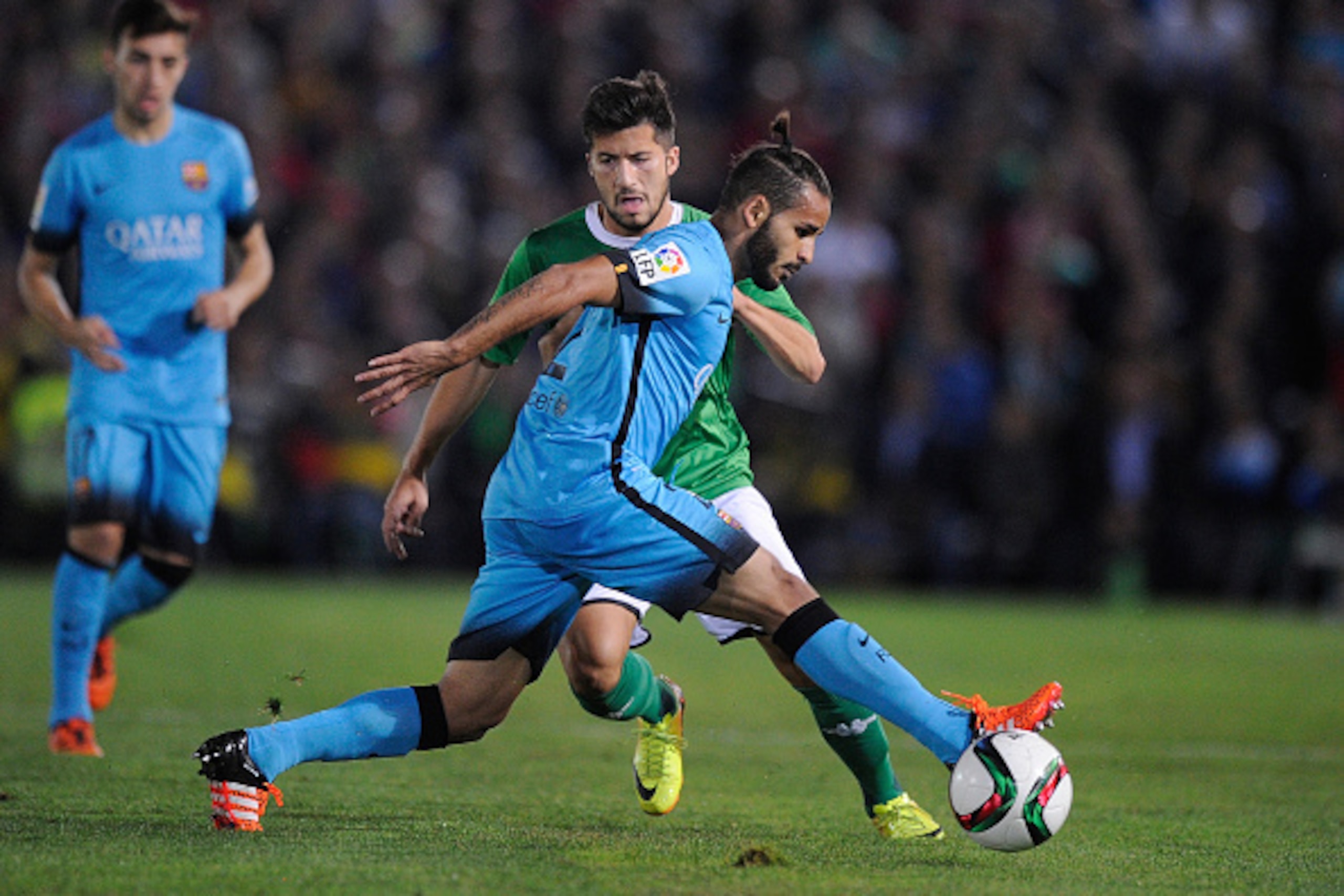 VILLANUEVA DE LA SERENA, SPAIN - OCTOBER 28:  Douglas Pereira dos Santos of FC Barcelona cuts off Tapia of C.F. Villanovense during of the Copa del Rey Last of 16 First Leg match between C.F. Villanovense and F.C. Barcelona at estadio Romero Cuerda on Oct