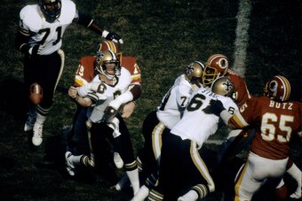 Washington Redskins defensive end Coy Bacon (79) lays a hard hit on Saints quarterback Archie Manning (8) during the Redskins 22-14 victory over the New Orleans Saints on October 26, 1980 at RFK Stadium in Washington, D.C. (Photo by Nate Fine/Getty Images