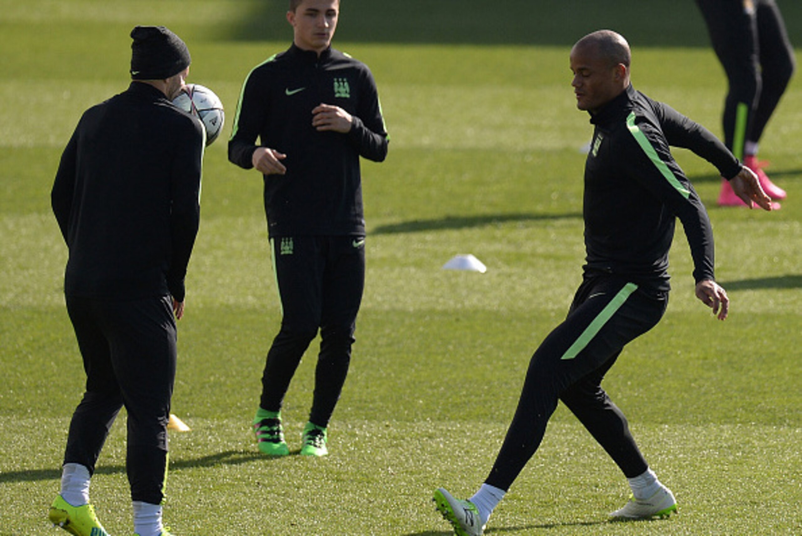 Manchester City's Belgian defender Vincent Kompany (R) kicks a ball into the face of teammate Manchester City's Argentinian striker Sergio Aguero (L) during a team training session at the City Football Academy in Manchester, north west England, on March 1