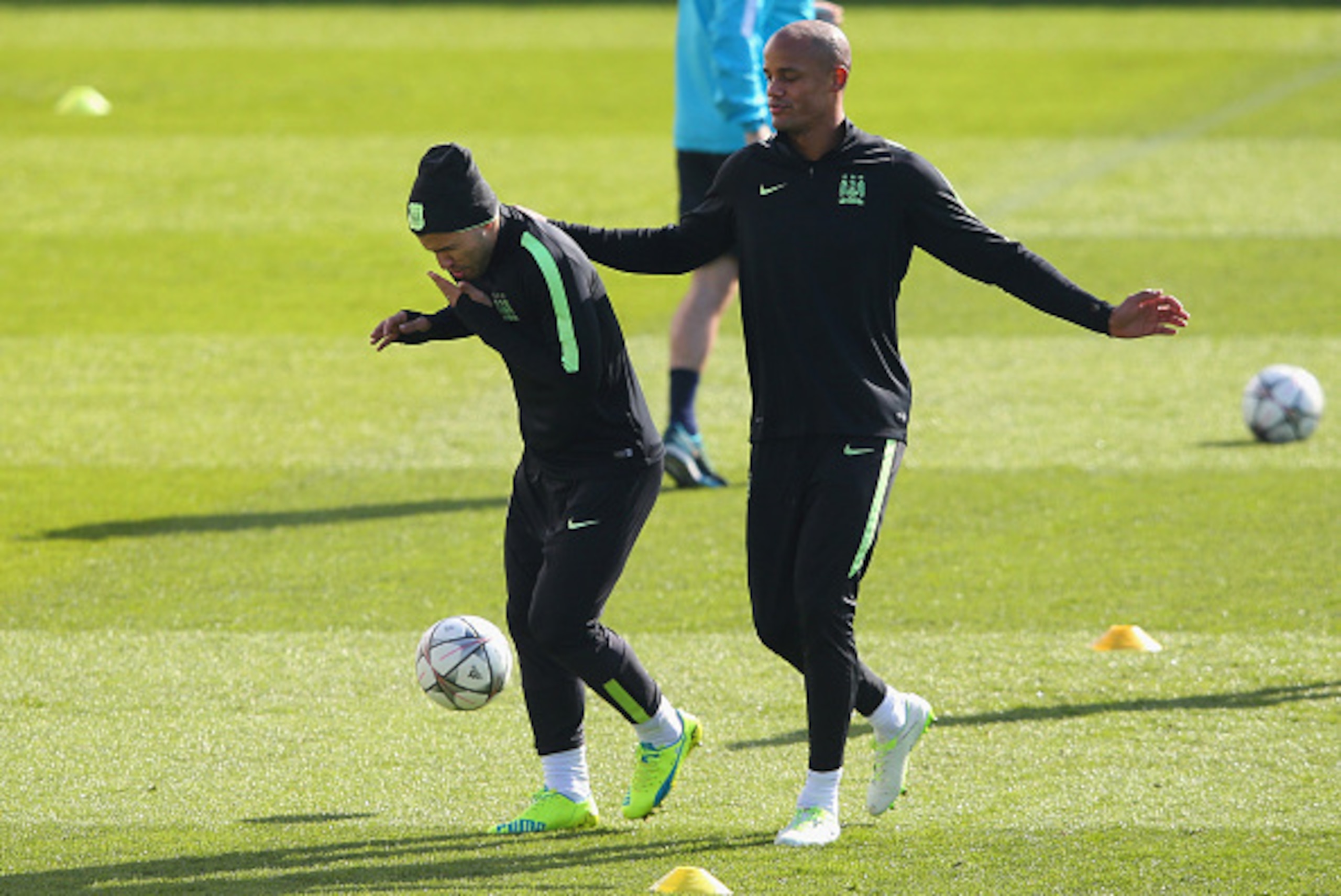 MANCHESTER, ENGLAND - MARCH 14:  Vincent Kompany of Manchester City checks on Sergio Aguero after hitting him in the face with the ball during a training session at the Manchester City Football Academy on March 14, 2016 in Manchester, United Kingdom.  (Ph
