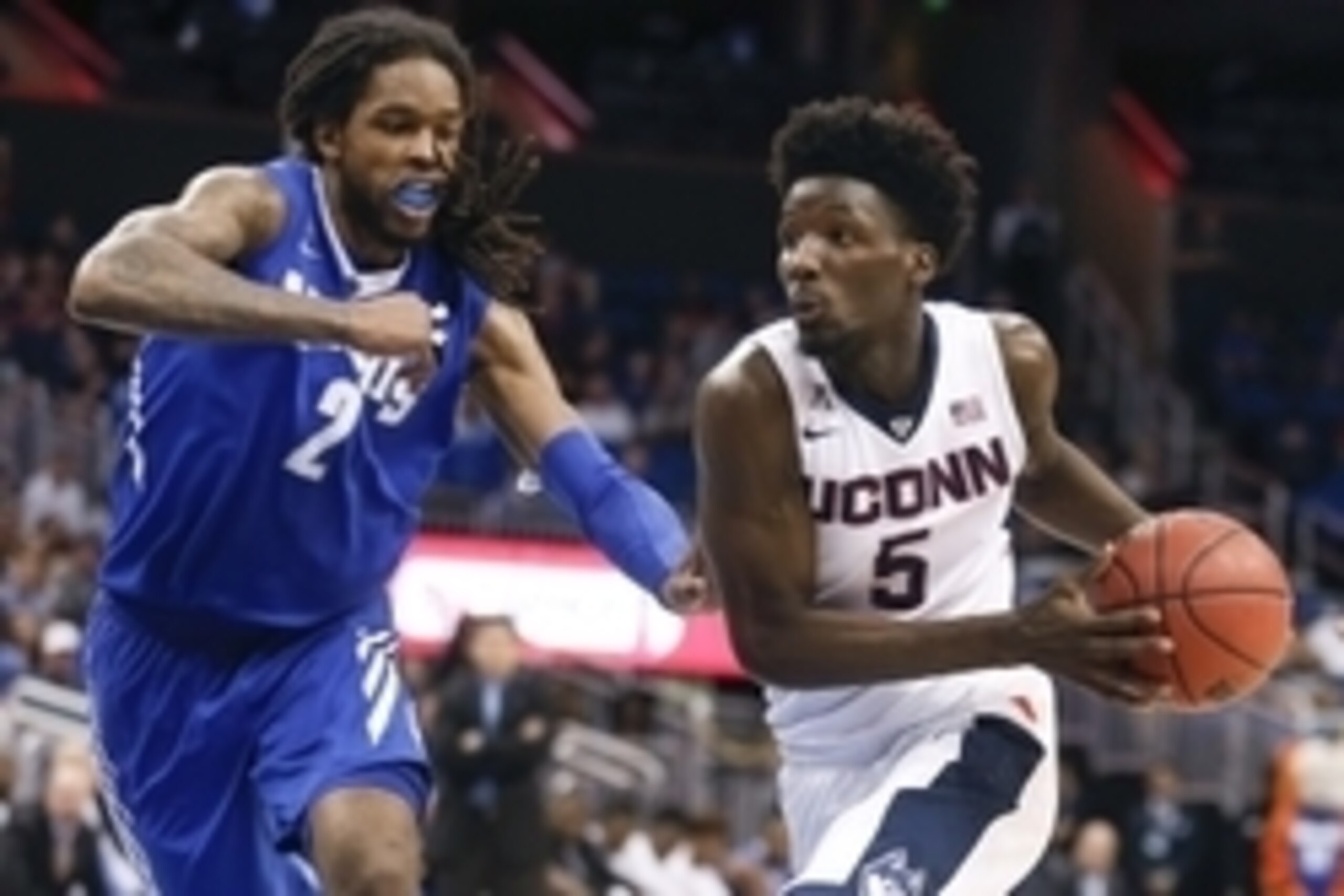 Mar 13, 2016; Orlando, FL, USA; Connecticut Huskies guard Daniel Hamilton (5) drives past Memphis Tigers forward Shaq Goodwin (2) during the second half of the AAC Conference tournament at Amway Center. Connecticut won 72-58. Mandatory Credit: Reinhold Ma