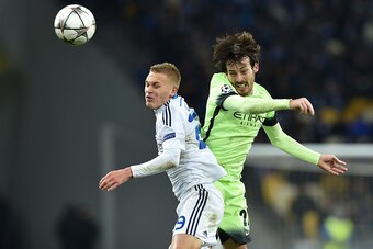 Dynamo Kiev's Ukrainian midfielder Vitaliy Buyalskiy (L) vies with Manchester City's Spanish midfielder David Silva during the UEFA Champions league round of 16, first leg, football match FC Dynamo Kyiv vs Manchester City  FC at the NSC Olimpiski stadium 