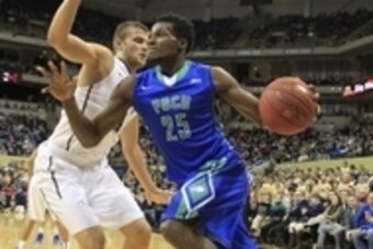 Dec 30, 2014; Pittsburgh, PA, USA; Florida Gulf Coast Eagles forward Marc-Eddy Norelia (25) dribbles the ball around Pittsburgh Panthers forward Ryan Luther (left) during the first half at the Petersen Events Center. Mandatory Credit: Charles LeClaire-USA