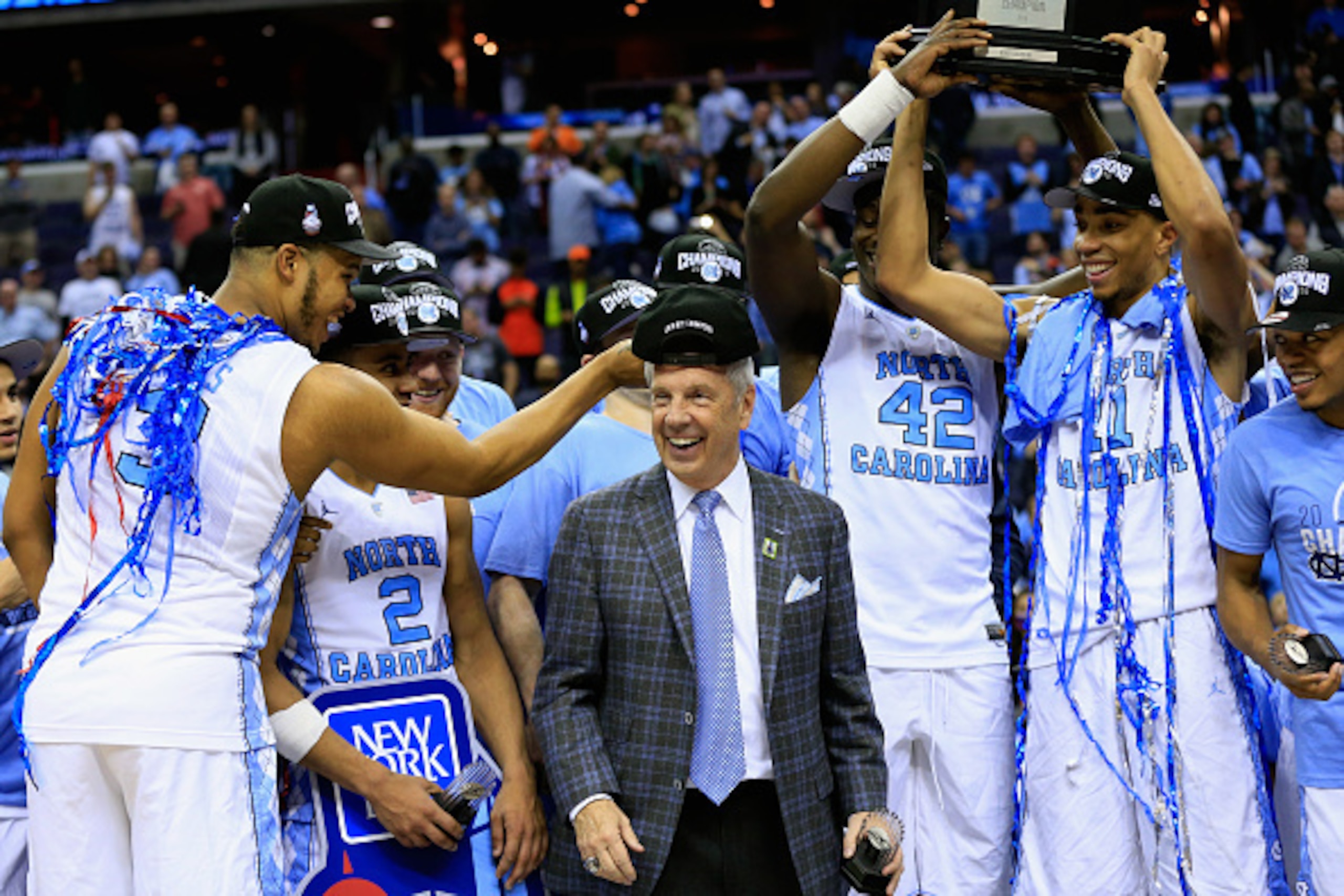 WASHINGTON, DC - MARCH 12: Kennedy Meeks #3 of the North Carolina Tar Heels adjusts the hat of head coach Roy Williams of the North Carolina Tar Heels following their 61-57 win in the 2016 ACC Basketball Tournament at Verizon Center on March 12, 2016 in W