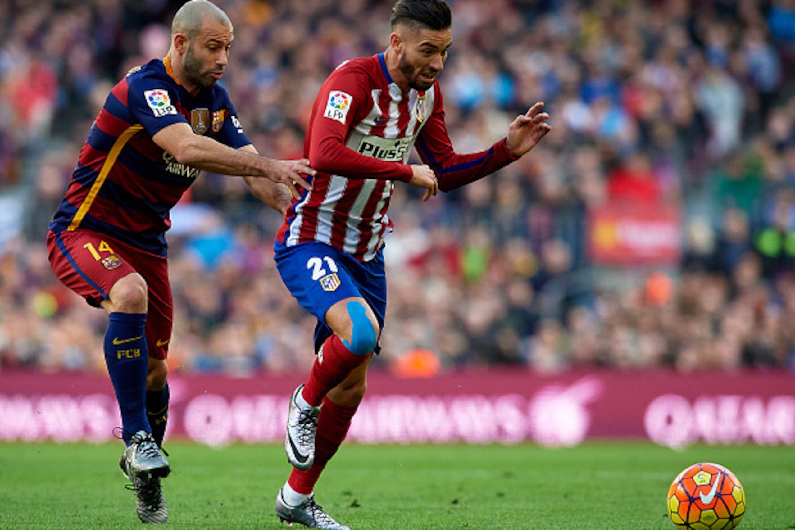 BARCELONA, SPAIN - JANUARY 30:  Javier Mascherano (L) of Barcelona competes for the ball with Yannick Carrasco of Atletico de Madrid during the La Liga match between FC Barcelona and Atletico de Madrid at Camp Nou on January 30, 2016 in Barcelona, Spain. 