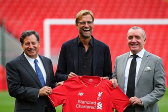 LIVERPOOL, ENGLAND - OCTOBER 09:  Jurgen Klopp at Anfield is unveiled as the new manager of Liverpool FC as he stands alongside Tom Werner (l) the chairman and Ian Ayre (r) the chief executive during a photocall at Anfield on October 9, 2015 in Liverpool,