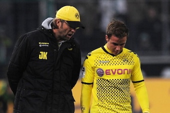 Dortmund's head coach Juergen Klopp (L) talks to Dortmund's midfielder Mario Goetze during the German first division Bundesliga football match Borussia Moenchengladbach vs Borussia Dortmund in Moenchengladbach, western Germany on December 3, 2011. The mat