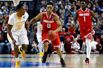 PORTLAND, OR - MARCH 19:  D'Angelo Russell #0 of the Ohio State Buckeyes dribbles past Treveon Graham #21 of the Virginia Commonwealth Rams in the first half during the second round of the 2015 NCAA Men's Basketball Tournament at Moda Center on March 19, 