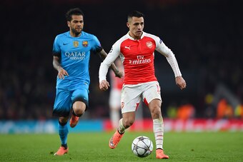 LONDON, ENGLAND - FEBRUARY 23:  Alexis Sanchez of Arsenal is pursued by Dani Alves of Barcelona during the UEFA Champions League round of 16, first leg match between Arsenal FC and FC Barcelona at the Emirates Stadium on February 23, 2016 in London, Unite