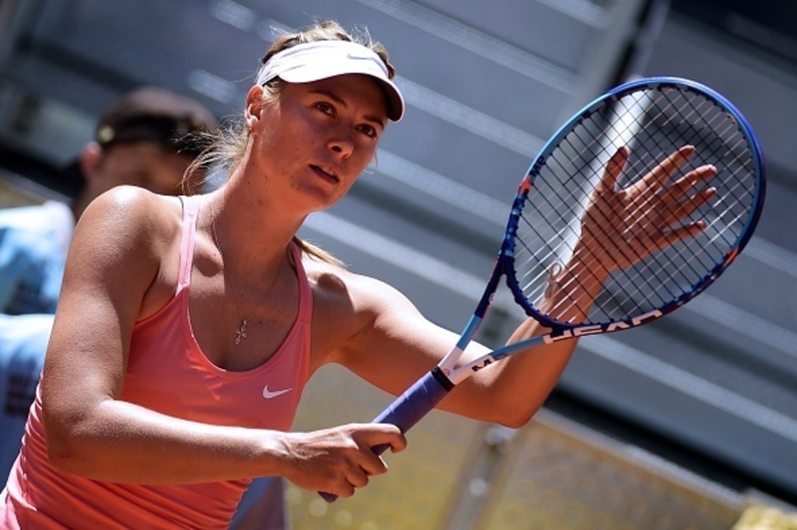Russian tennis player Maria Sharapova touches her racket at the end of her match against Colombian Mariana Duque Marino during day four of the Madrid Open tournament at the Caja Magica (Magic Box) sports complex in Madrid on May 5, 2015.  AFP PHOTO / PIER