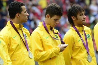 (FromL) Brazil's forward Leandro Damiao, Brazil's midfielder Oscar and Brazil's forward Neymar are pictured on the podium of the men's football final at Wembley stadium during the London 2012 Olympic Games on August 11, 2012 in London. Mexico defeated Bra