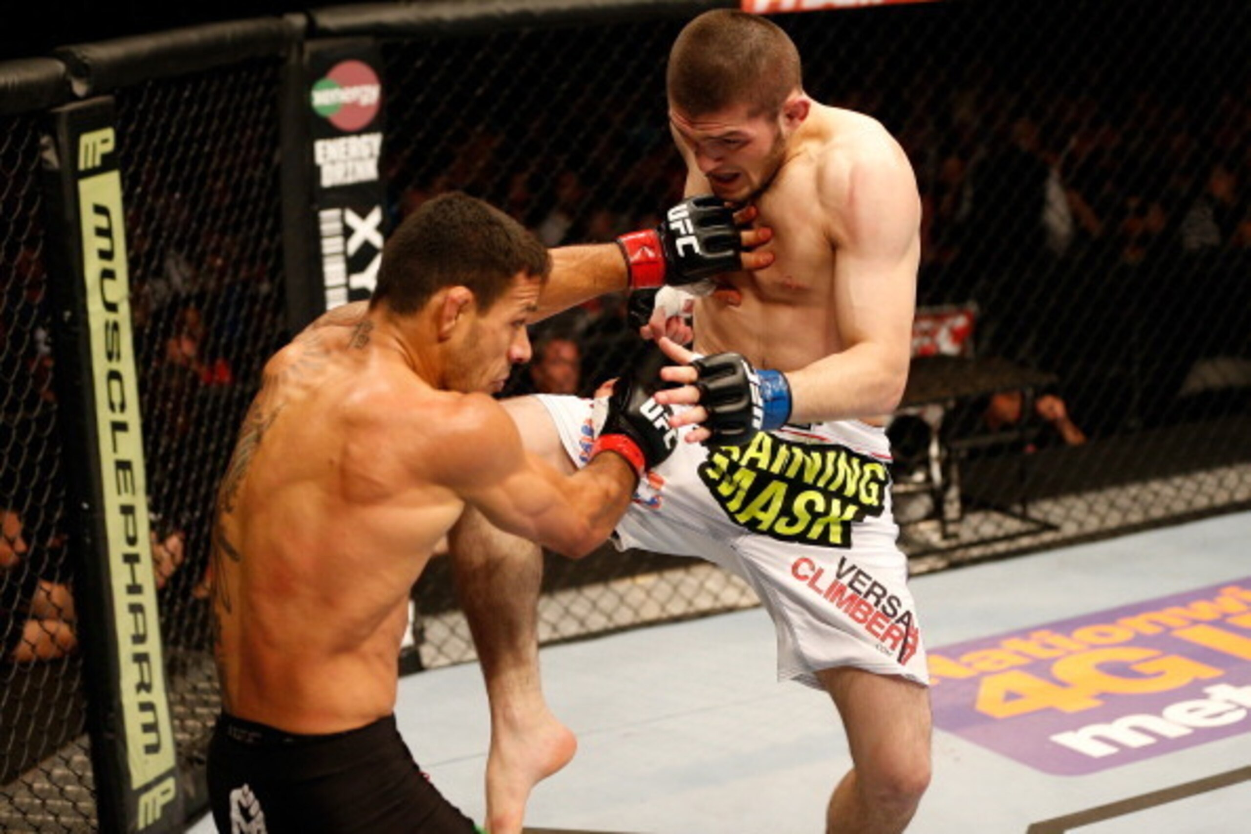 ORLANDO, FL - APRIL 19:  (R-L) Khabib Nurmagomedov lands a flying knee against Rafael dos Anjos in their lightweight bout during the FOX UFC Saturday event at the Amway Center on April 19, 2014 in Orlando, Florida. (Photo by Josh Hedges/Zuffa LLC/Zuffa LL