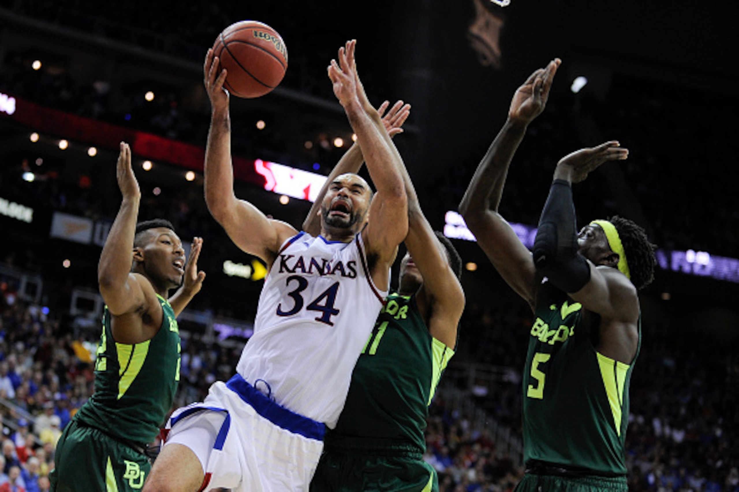 KANSAS CITY, MO - MARCH 11:  Perry Ellis #34 of the Kansas Jayhawks drives to the goal against King McClure #22, Terry Maston #31 and Johnathan Motley #5 of the Baylor Bears in the second half during the semifinals of the Big 12 Basketball Tournament at S