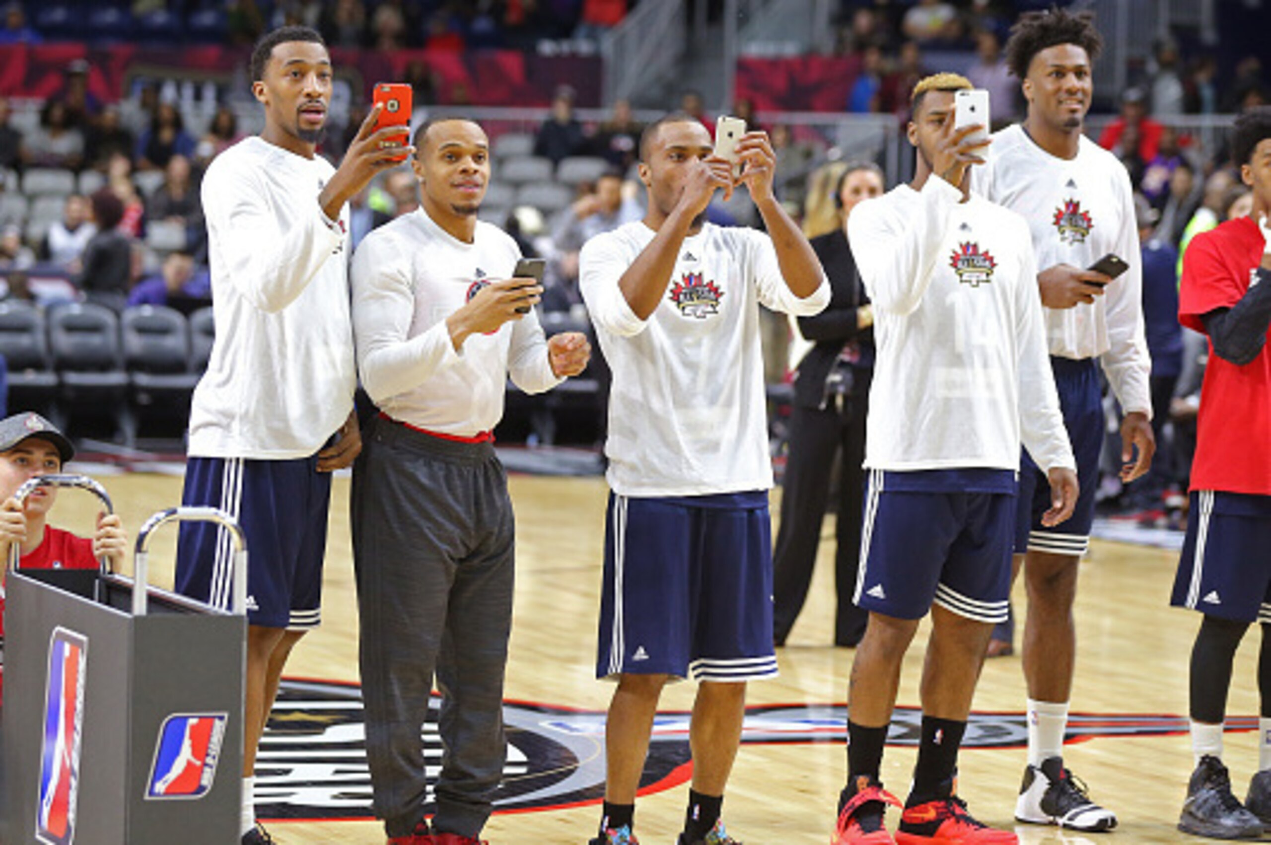 TORONTO, CANADA - FEBRUARY 13:  Players line up with their smart phones during the NBA D-League All-Star 3 Point Contest, presented by Kumho Tire, as part of 2016 All-Star Weekend at the Ricoh Coliseum on February 13, 2016 in Toronto, Ontario, Canada. NOT
