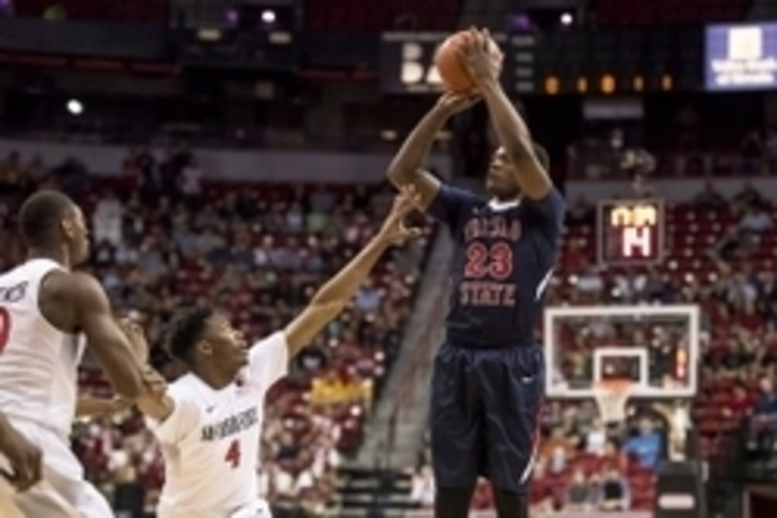 Mar 12, 2016; Las Vegas, NV, USA; Fresno State Bulldogs guard Marvelle Harris (23) shoots the ball as San Diego State Aztecs forward Skylar Spencer (0) and guard Dakarai Allen (4) defend in the first half during the Mountain West Conference Tournament at 