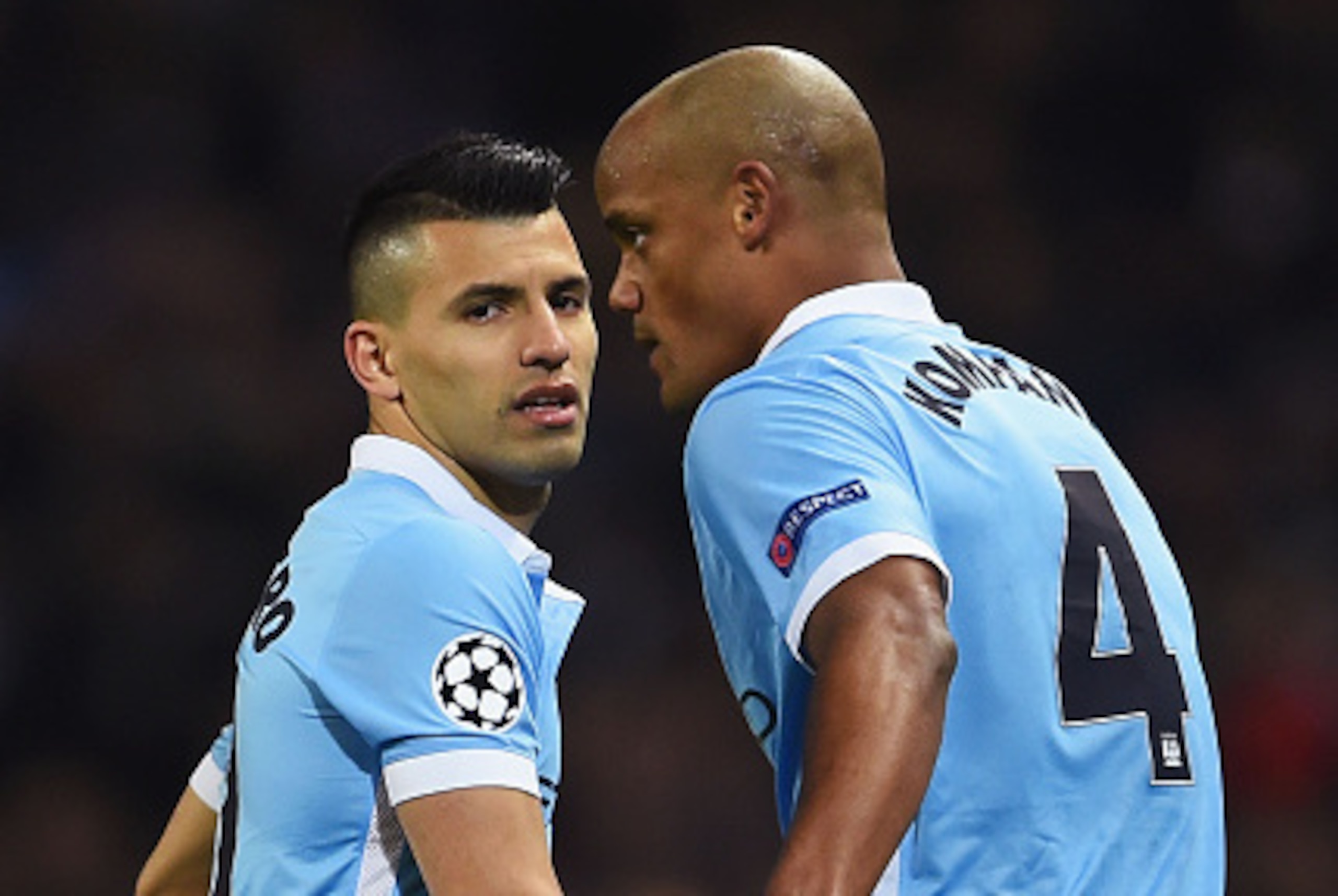 MANCHESTER, ENGLAND - MARCH 15:  An injured Vincent Kompany of Manchester City (4) speaks to Sergio Aguero of Manchester City as he leaves the pitch during the UEFA Champions League round of 16 second leg match between Manchester City FC and FC Dynamo Kyi