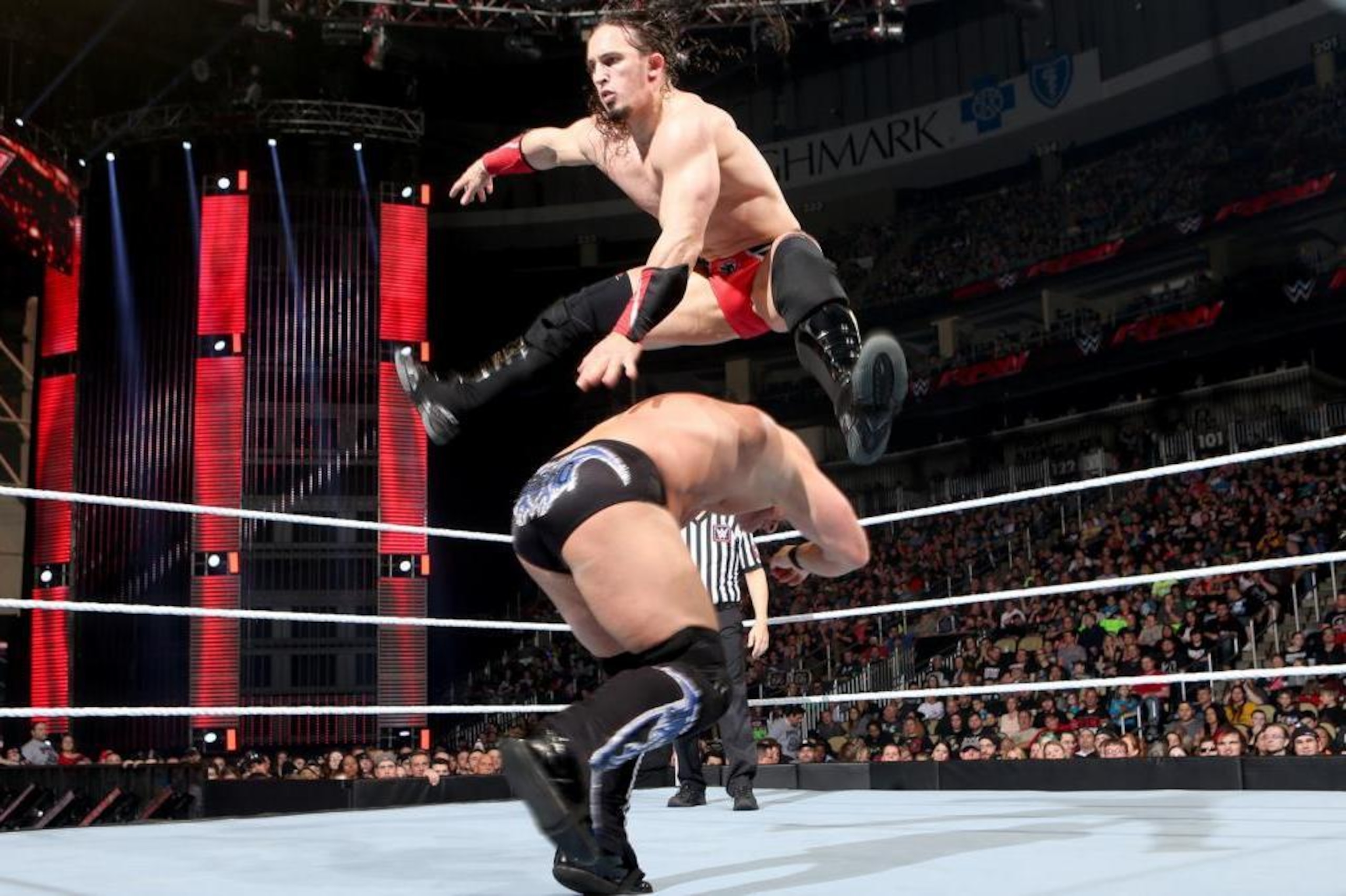 Neville leaps over Chris Jericho. Neville leaps over Chris Jericho.