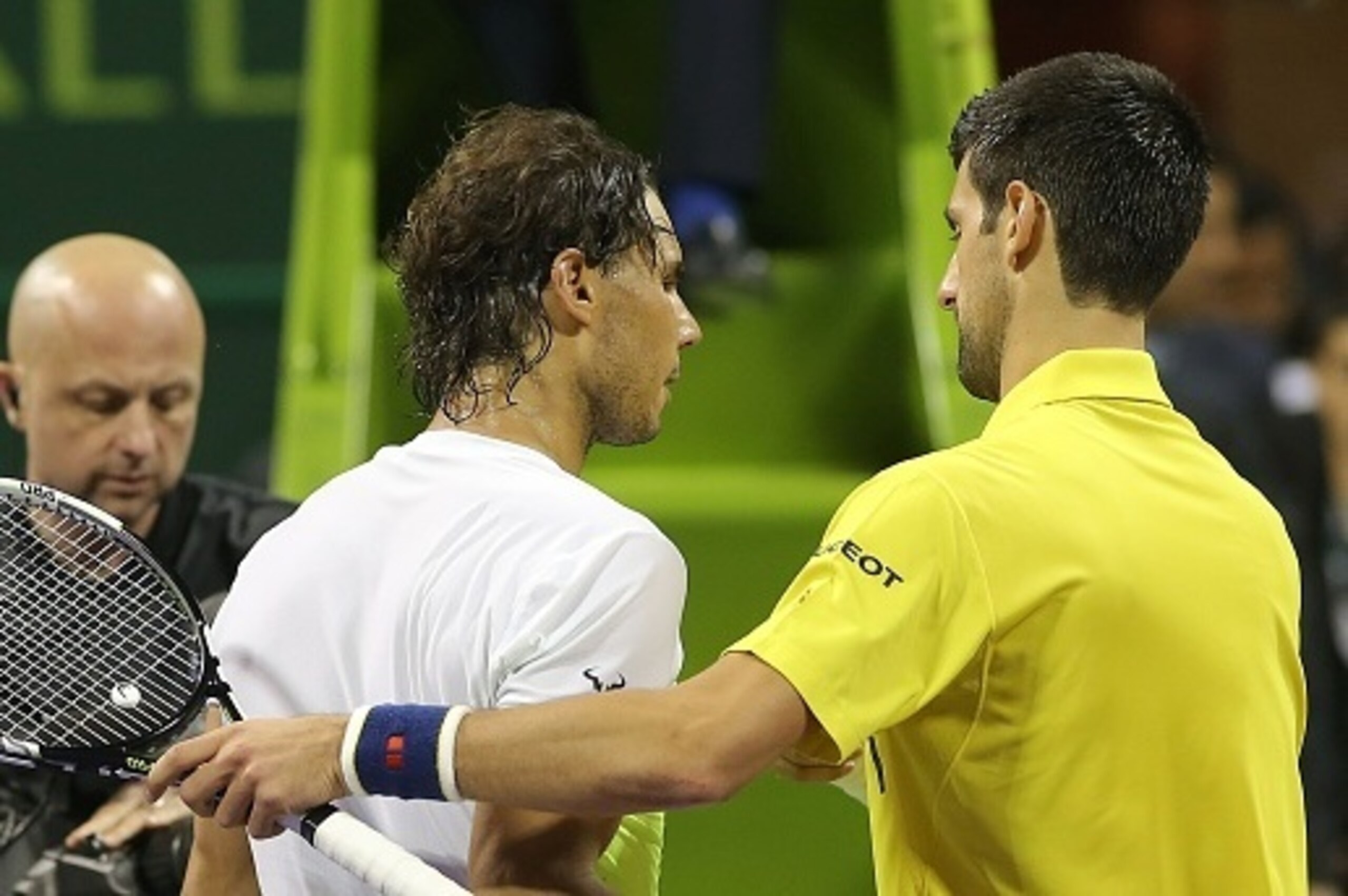 Novak Djokovic (R) of Serbia shakes hands with Rafael Nadal  of Spain after winning the final of the Qatar Open tennis tournament on January 9, 2016, in Doha. Djokovic won his 60th ATP title with his crushing 6-1, 6-2 triumph over Nadal in the Qatar Open 