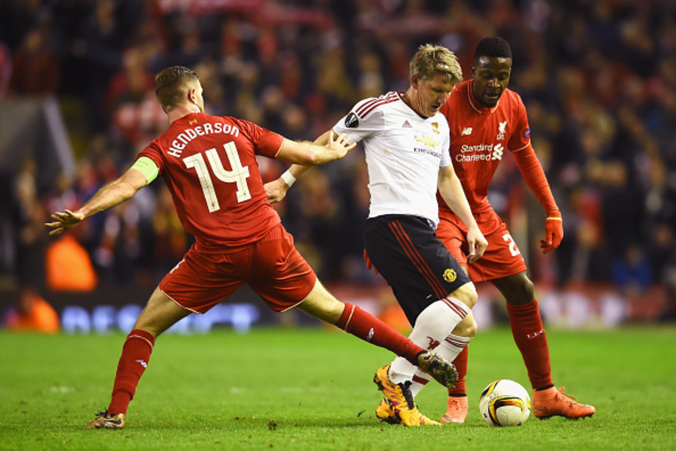 LIVERPOOL, ENGLAND - MARCH 10:  Bastian Schweinsteiger of Manchester United takes on Jordan Henderson and Divock Origi of Liverpool during the UEFA Europa League Round of 16 first leg match between Liverpool and Manchester United at Anfield on March 10, 2