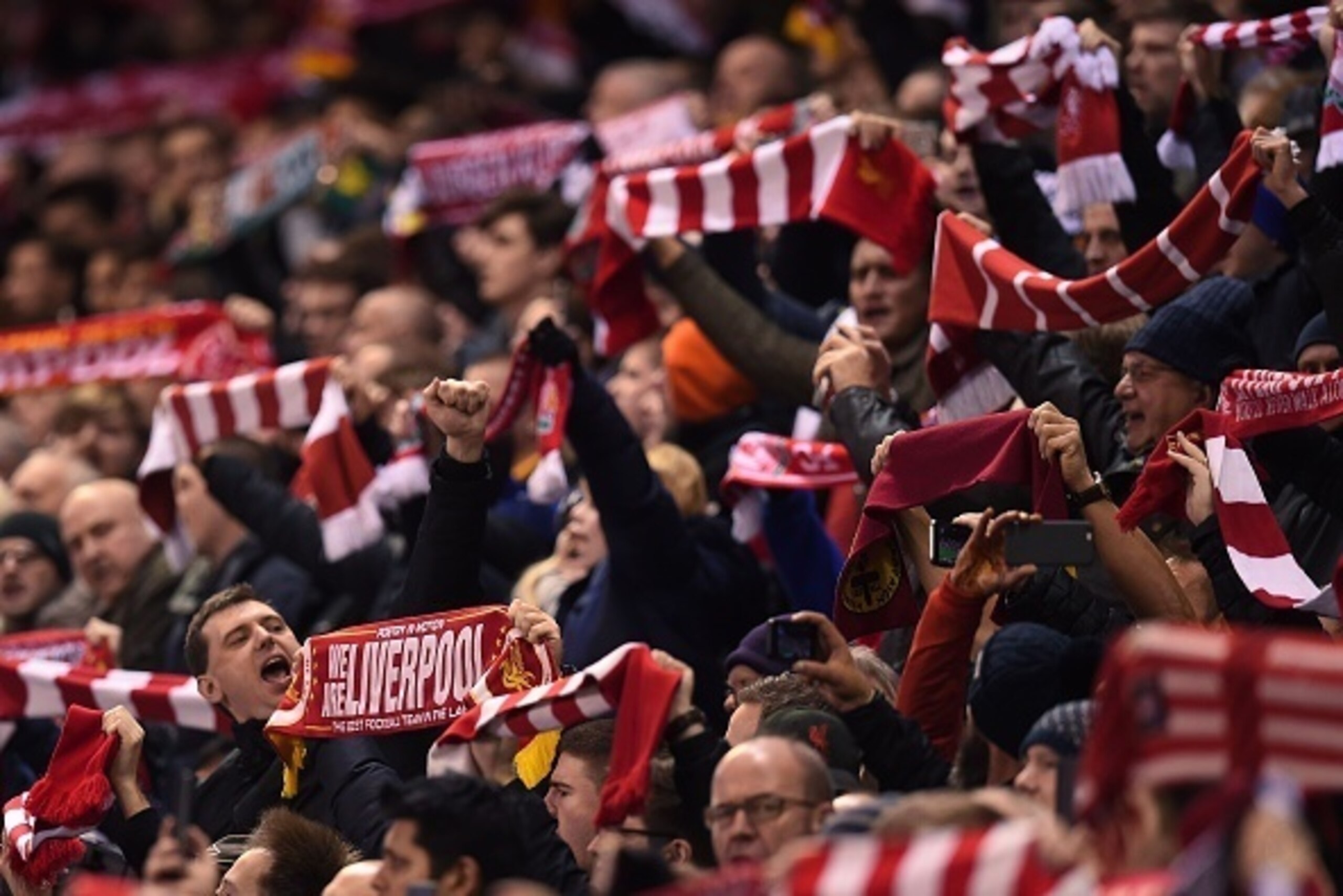 Liverpool fans wave flags and banners ahead of the UEFA Europa League round of 16, first leg football match between Liverpool and Manchester United at Anfield in Liverpool, northwest England on March 10, 2016. / AFP / PAUL ELLIS        (Photo credit shoul