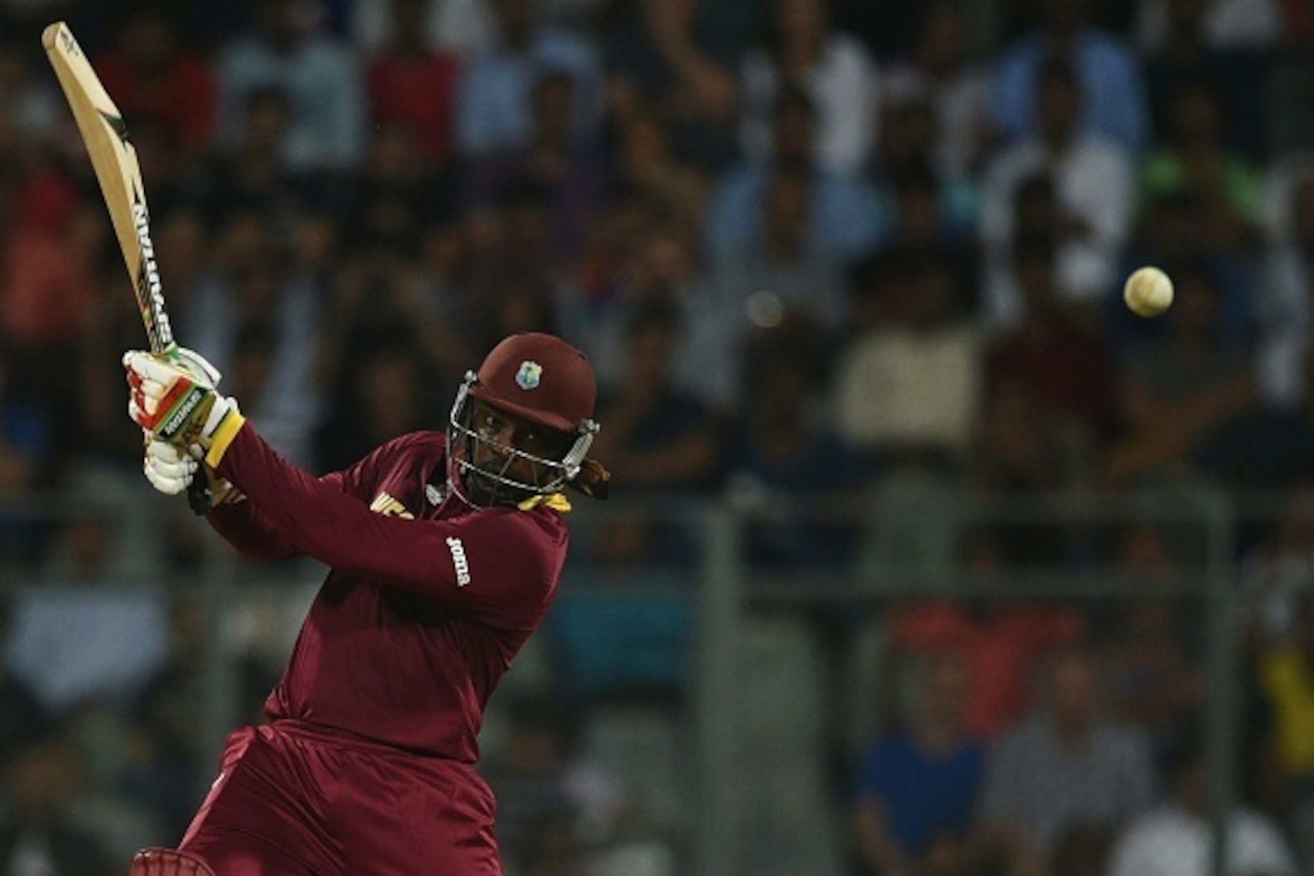 West Indies's Chris Gayle plays a shot on way to his century (100 runs) during the World T20 cricket tournament match between England and West Indies at The Wankhede Cricket Stadium in Mumbai on March 16, 2016.
 / AFP / INDRANIL MUKHERJEE        (Photo cr