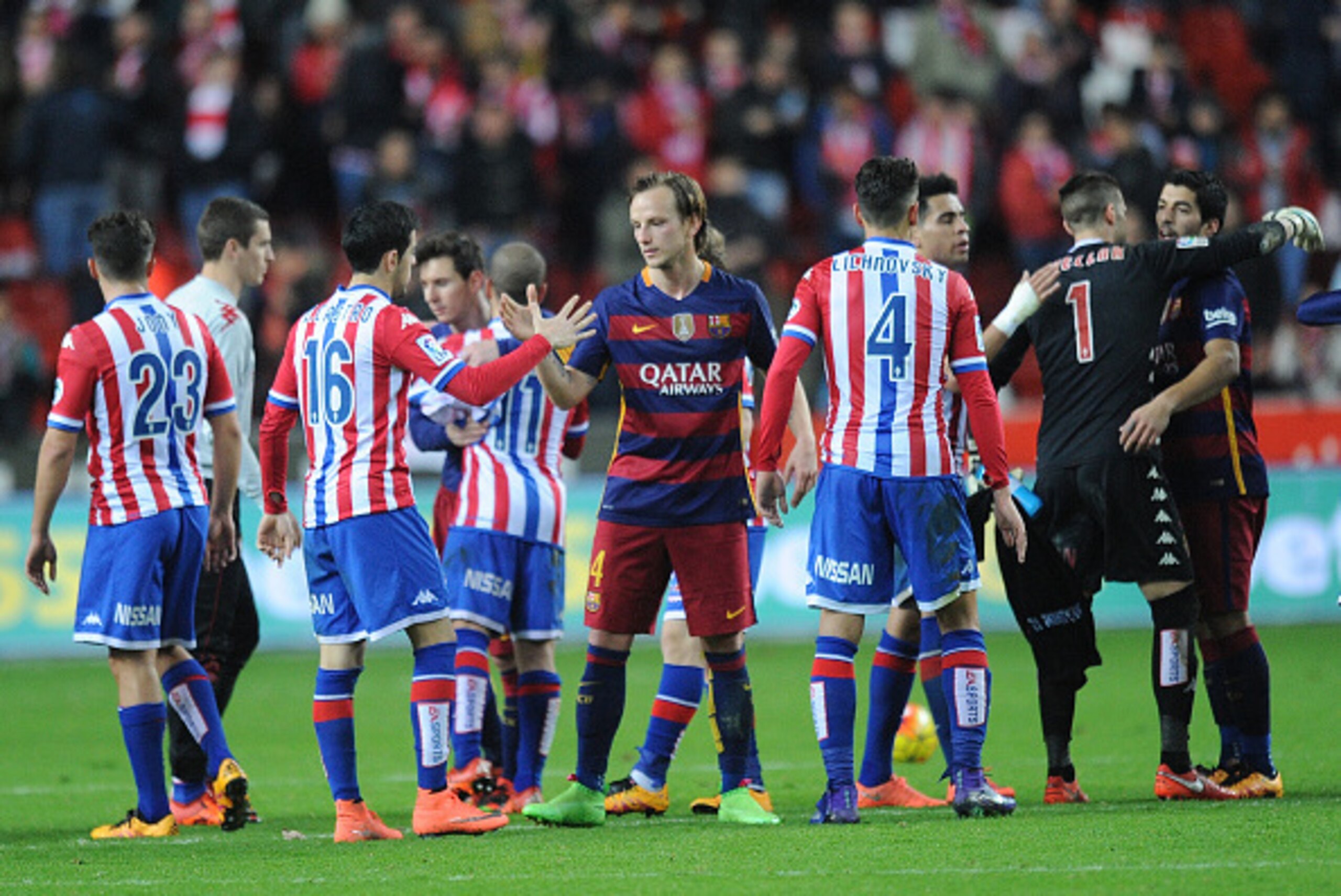 GIJON, SPAIN - FEBRUARY 17:   Ivan Rakitic of FC Barcelona shakes hands with  Carlos Castro of Sporting Gijon at the end of the La Liga match between Sporting Gijon and FC Barcelona at Estadio El Molinon on February 17, 2016 in Gijon, Spain.  (Photo by De