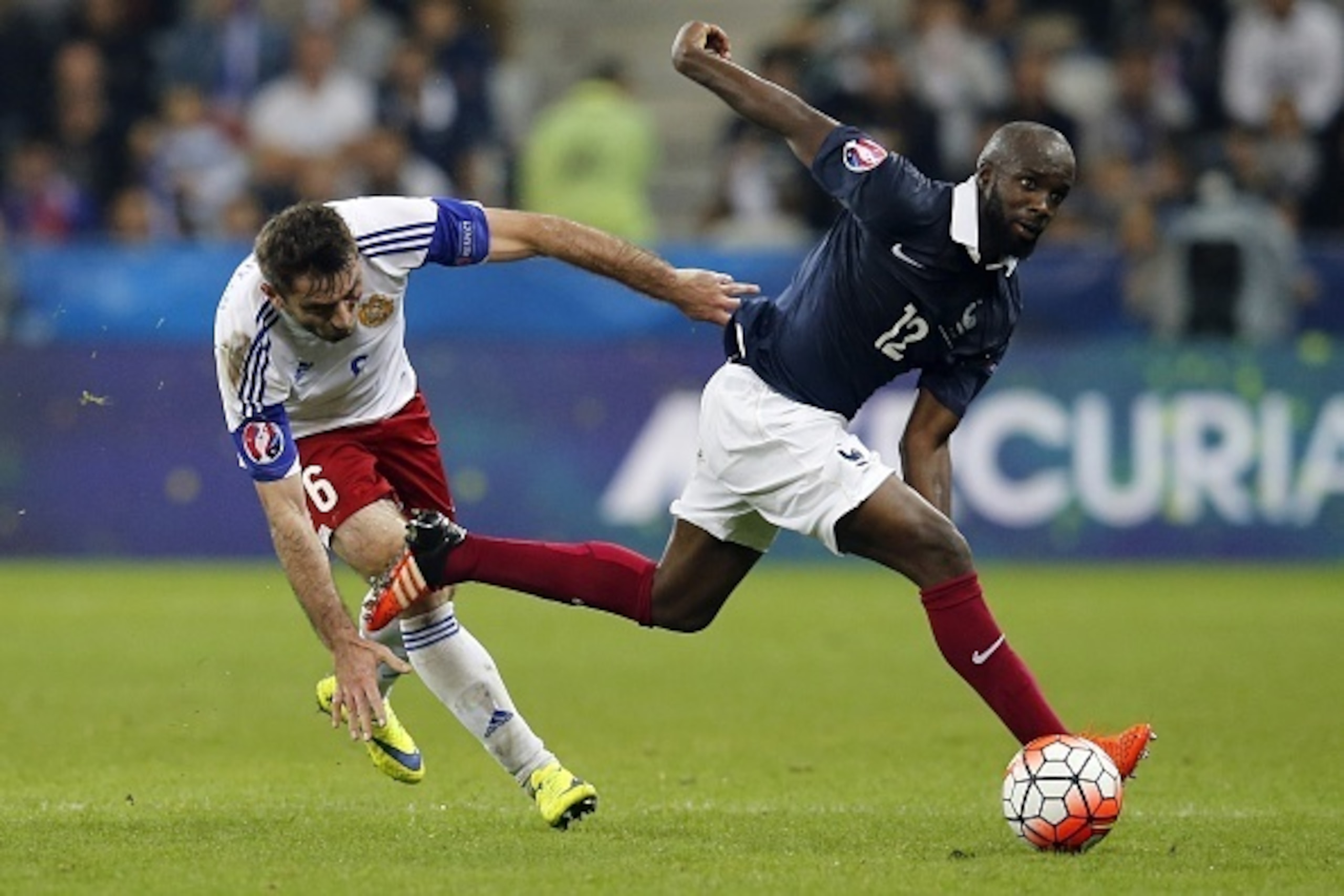 France's midfielder Lassana Diarra (R) vies for the ball Armenia's midfielder Karlen Mkrtchyan during the friendly football match between France and Armenia on October 8, 2015 at the Allianz Riviera stadium in Nice, southeastern France. AFP PHOTO / VALERY